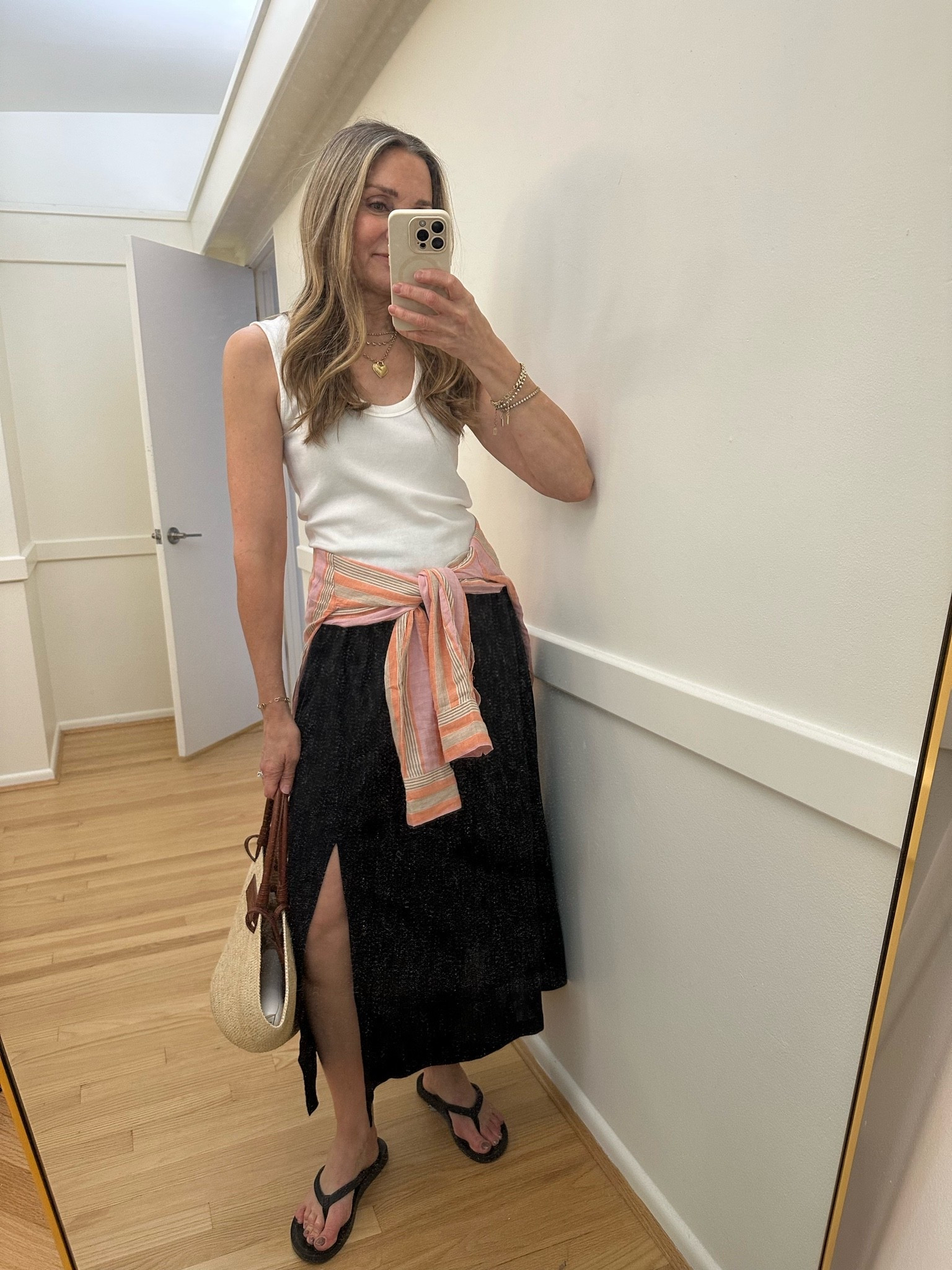 Summer outfit of the day!😎 Live a linen midi skirt and this one from @Quince is perfection with the cool side slit and perfect length. This is my current fave bra-friendly tank from @Anthropologie  and love this colorful @zsupplyclothing striped linen shirt. The comfiest flip flops and iconic @SEZANE summer straw bag. Wearing size small, I’m 5’6”.

#LTKootd #LTKOver40 #LTKTravel