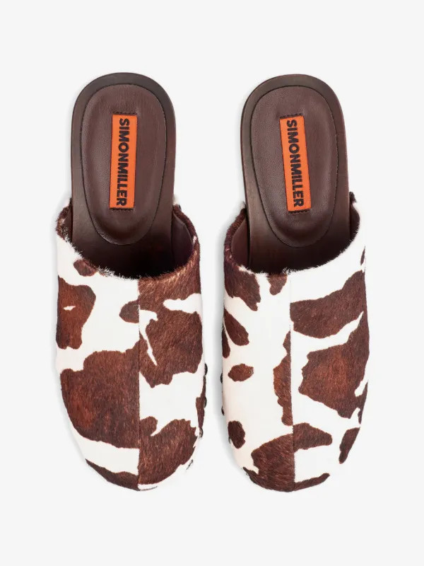 Rio cow-print wood clog mules | Farfetch Global
