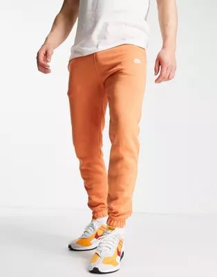 Nike Club loose fit cuffed joggers in orange | ASOS (Global)