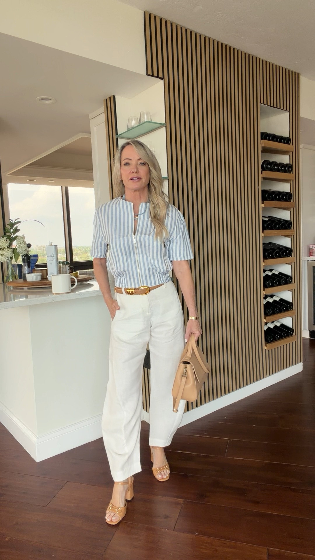 An easy summer outfit you’ll wear on repeat—striped top, white linen pants, tan accessories, and comfortable block heels. Timeless, polished, and petite-friendly.