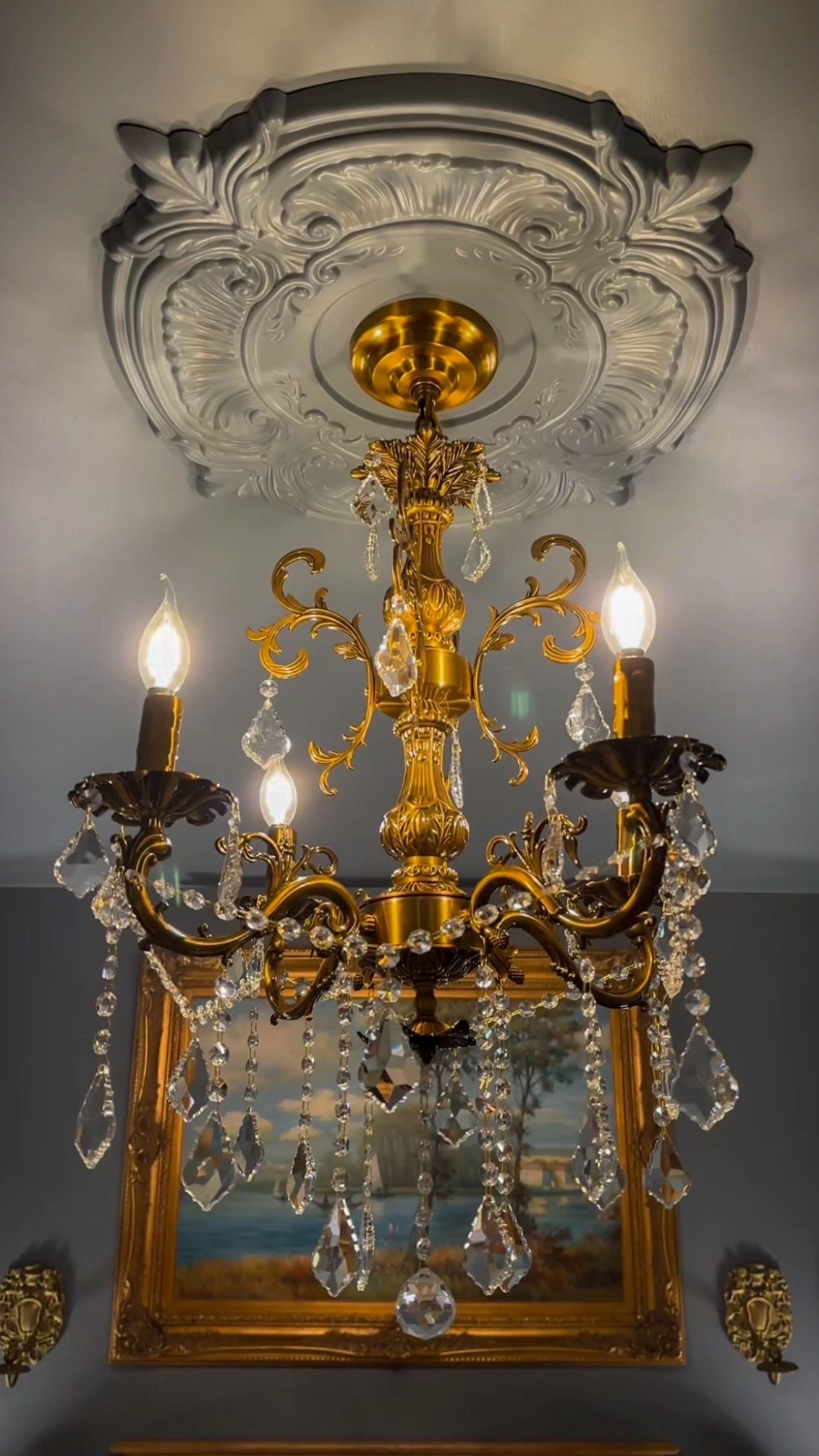 A gold chandelier paired with an ornate ceiling appliqué that frames it beautifully overhead. The added detail brings depth and grandeur, turning the light fixture into a true architectural moment. 

#GoldChandelier #CeilingDetails #OrnateDesign #TimelessInteriors #StatementLighting #HomeDecor #DesignDetails #callsigndesign