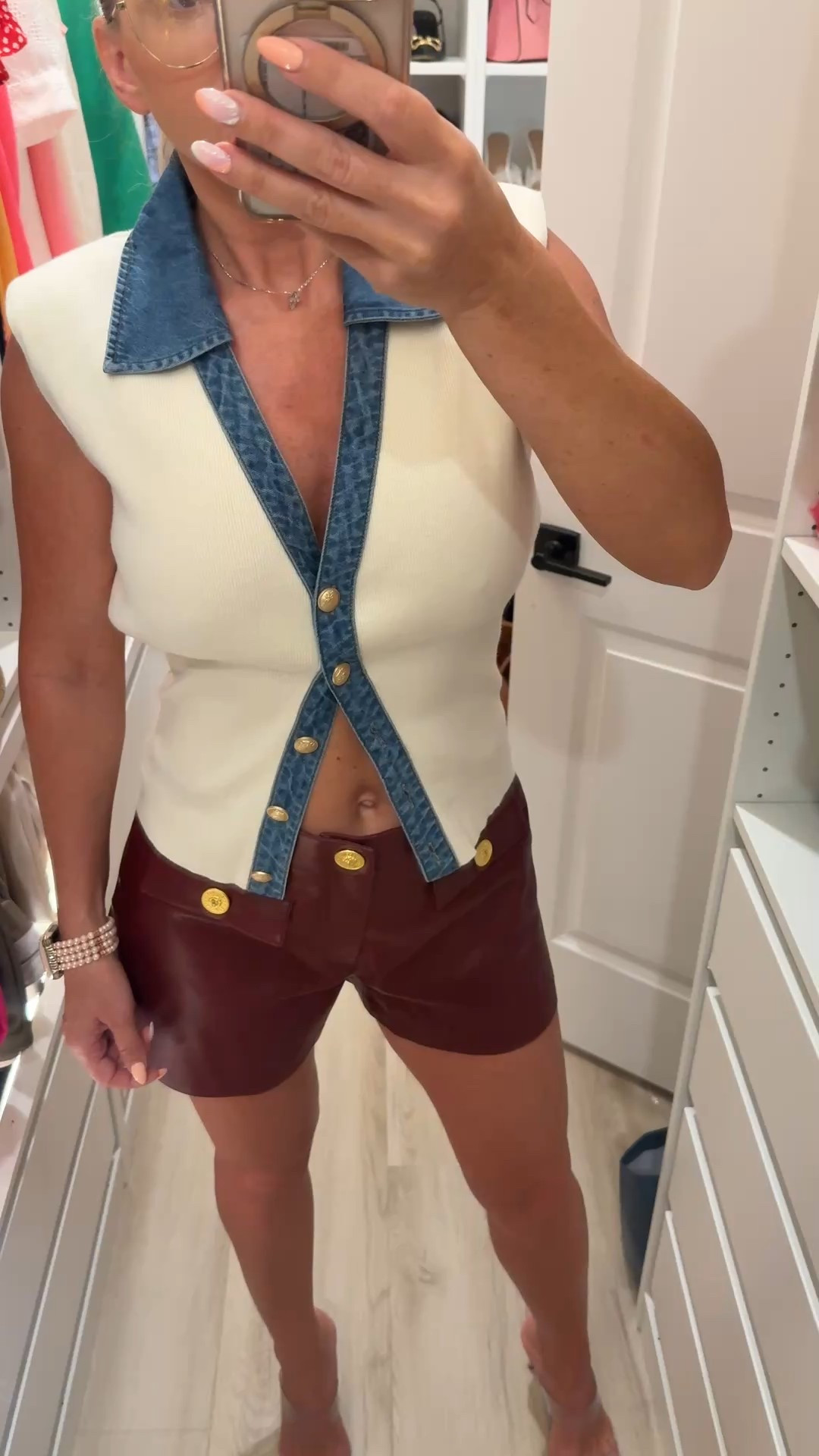 Burgundy leather shorts for this fall and winter. They have beautiful golden buttons. Runs big so size down. The top is cream sweater vest with blue jeans collar. Super cute. Has golden buttons as well and shoulder pads. Love this outfit. Pair with pumps or cream boots. 

#LTKootd #LTKFindsUnder100 #LTKStyleTip