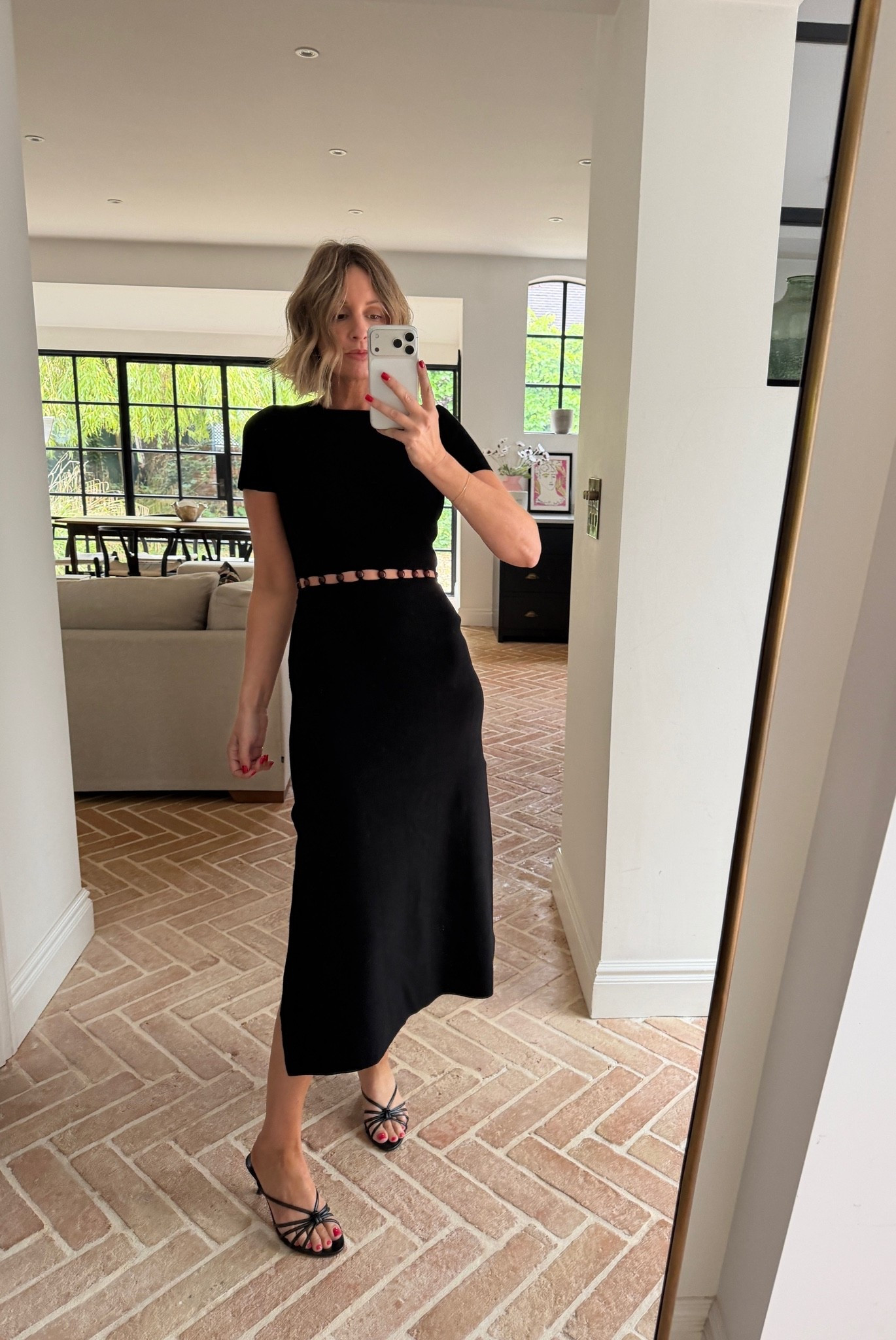 black midi dress, cutout waist dress, ring detail dress, short sleeve midi dress, fitted knit dress, black strappy sandals, black heeled sandals, evening dress, date night dress, cocktail dress, little black dress, minimalist evening look

#LTKsummer #LTKpartywear #LTKdresses