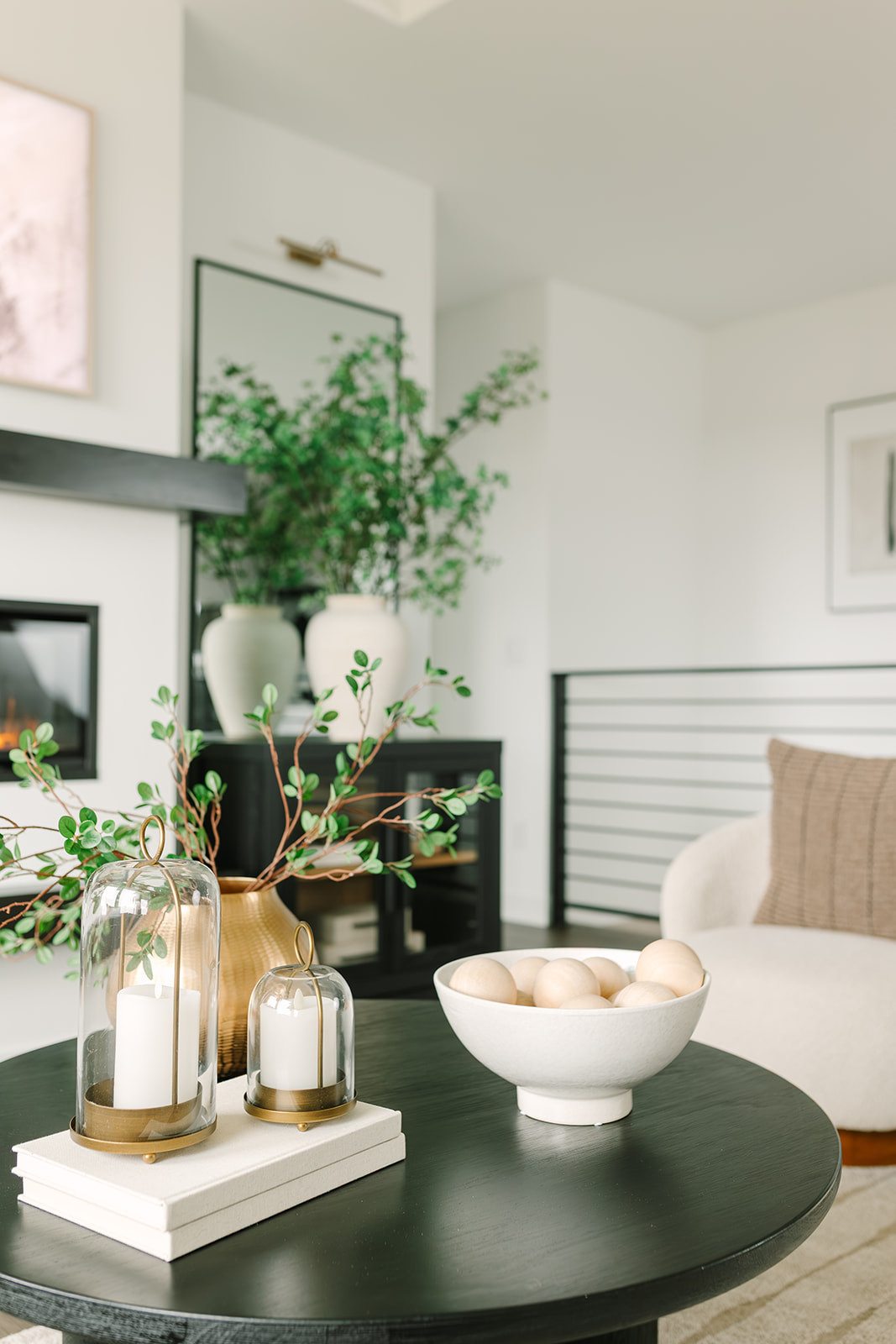 One of my favorite views in my living room 🤍 Cozy, calm, and exactly how I love it, with gold hurricane candles, vases and stems, cozy chairs, and simple decor layered together. 

 

#LTKHome