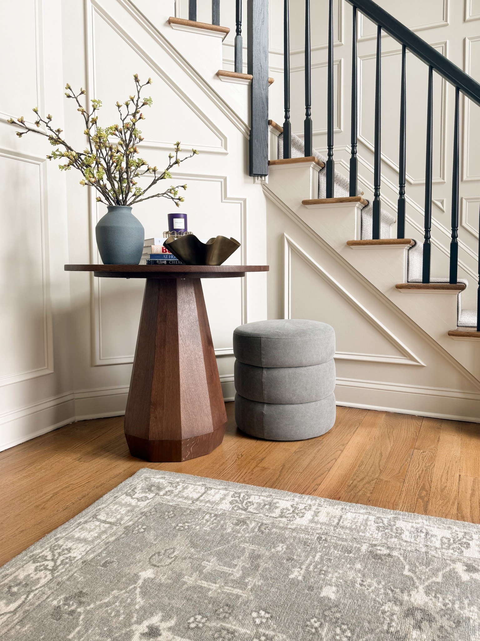 One of my favorite entryway transformations and proof that a can of paint and some trim can go a long way! We trimmed out this entryway and upstairs hallway, painted it the perfect neutral (BM Edgecomb Gray), installed a statement chandelier and added a gorgeous table, ottoman and accessories to the foyer 🙌🏻 

#LTKdayinmylife #LTKHome #LTKSeasonal