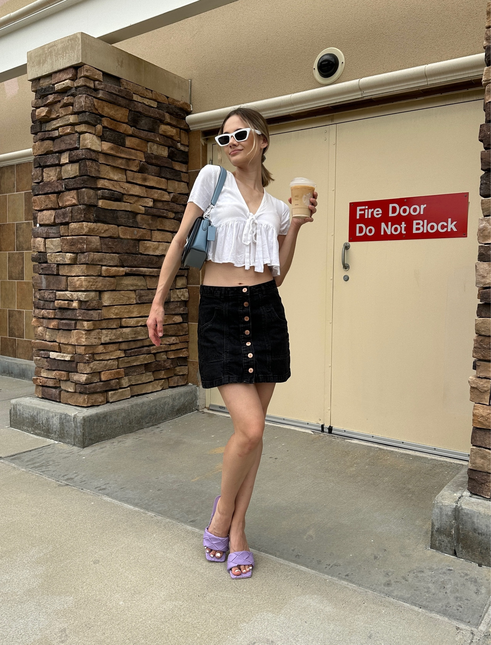 Neutral summer outfit with colorful accessories - also perfect for warm fall days! 

Denim skirt, mini skirt, skirt outfit, black denim, white ruffle hem top, Coach bag, purple heels, woven heals, white cat eye sunglasses, girly style, classy outfit, date night outfit, casual look, style inspo 

#LTKSeasonal #LTKFind #LTKstyletip