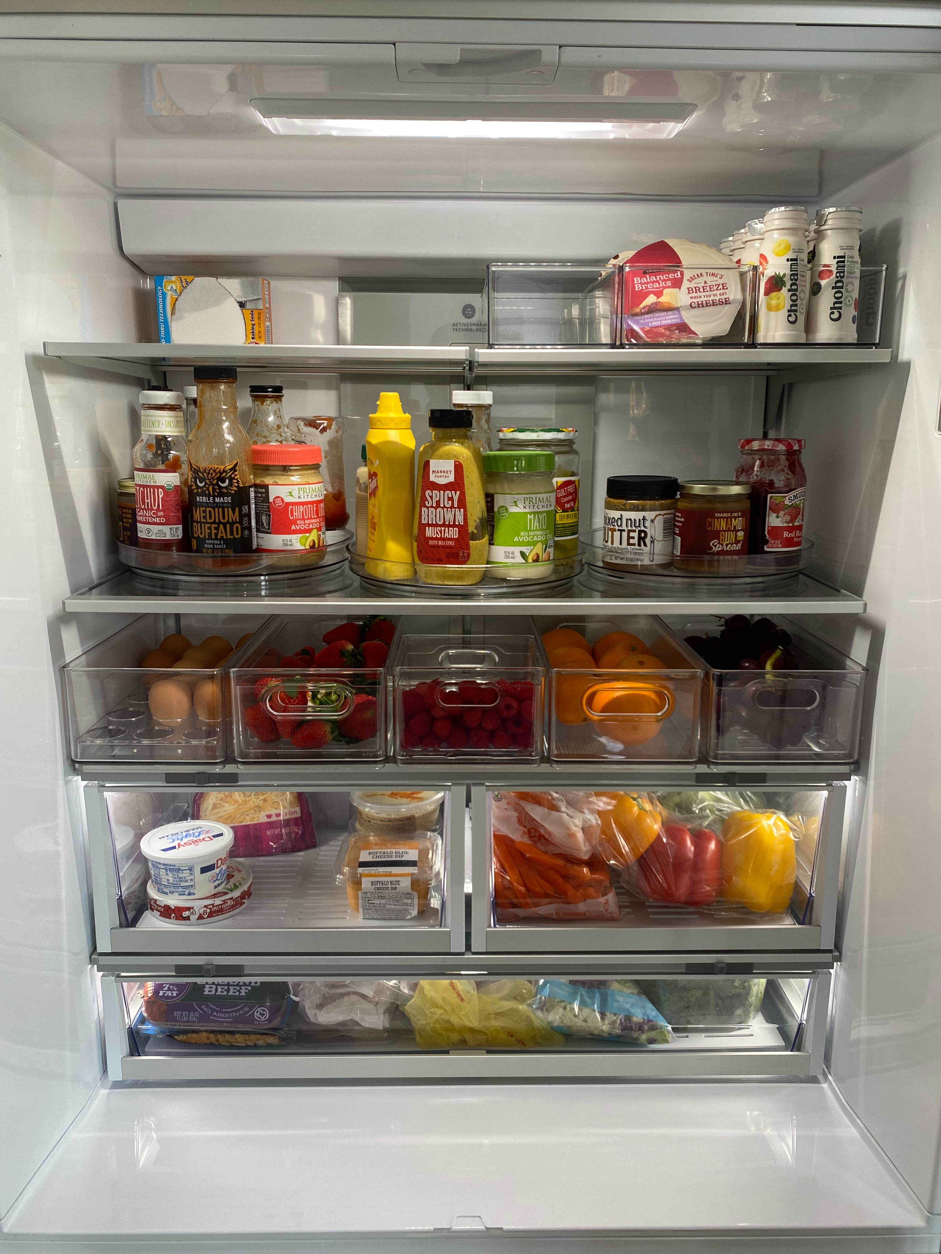 Clear bins and simple containment make it easy to keep the fridge organized, visible, and functional for everyday use.

1. Turntable for condiments
Keeps sauces and dressings easy to reach and prevents items from getting lost in the back.

2. Bin on the top shelf
Creates a contained zone for smaller items and keeps the shelf looking clean.

3. Egg holder (18-count)
A space-saving way to store eggs while keeping the carton off the shelf.

4. Small berry bin (raspberries)
Keeps berries fresh with proper airflow and includes a removable colander for easy rinsing.

5. Large berry and produce bins (oranges, grapes, strawberries)
Clear bins that separate produce categories and make it easy to grab what you need without rearranging the fridge. 

 #LTKHome #LTKFindsUnder50 #LTKFindsUnder100