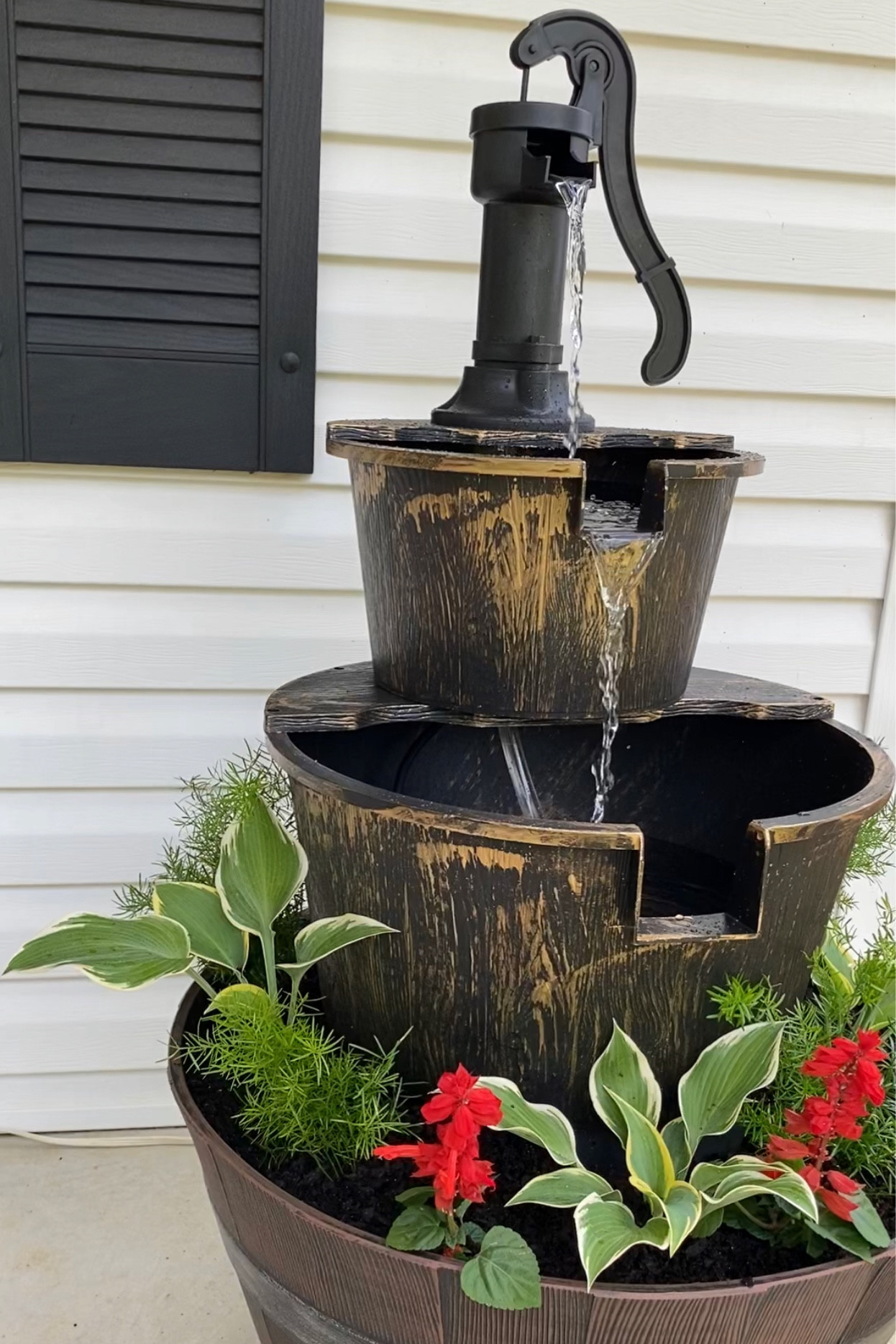 Gorgeous two tiered outdoor fountain turned into 3 tier with wine barrel planter. 
Wine barrel planter, rustic bronze  outdoor fountain, from Amazon, also linking some from Walmart 
