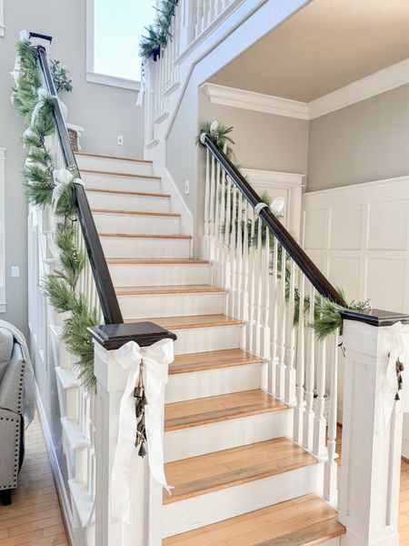Christmas stairs with garland, bows, and bells 

#LTKSeasonal #LTKhome #LTKHoliday