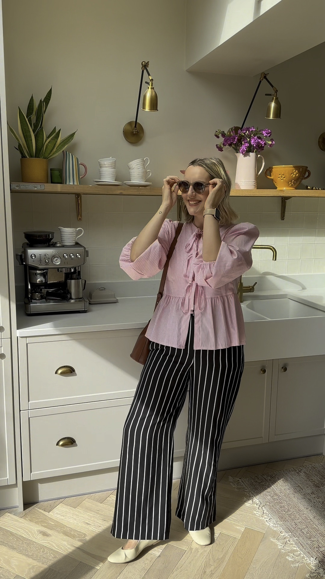 Summer Work Outfit of the Day, featuring a Ganni Dupe blouse. 
Marks & Spencer Mary Jane shoes, River Island striped trousers via Vinted (size 12), Hello Moon Shop pink striped Ganni dupe blouse (size M/L), Sezane bucket bag, Ray-ban sunglasses.

#LTKuk #LTKworkwear #LTKsummer