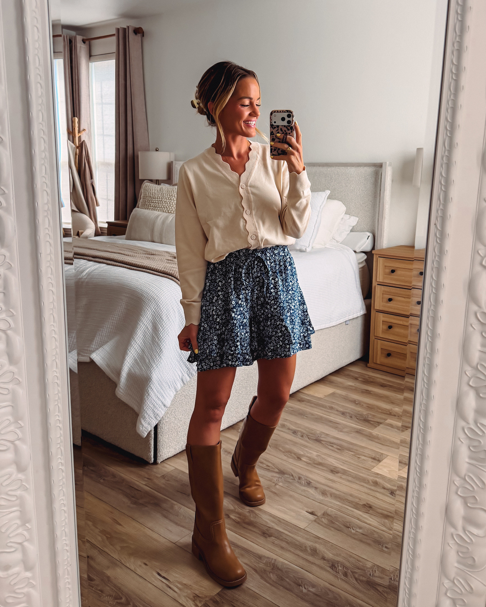 Feminine fall vibes all the way! This cream scalloped cardigan is such a pretty layering piece over a navy floral ruffle mini skirt. Tall cognac boots pull it all together for that perfect cozy-meets-cute feel. Perfect for coffee dates, weekend strolls, or a fun afternoon exploring downtown! 

 #LTKootd #LTKmomlife #LTKSeasonal