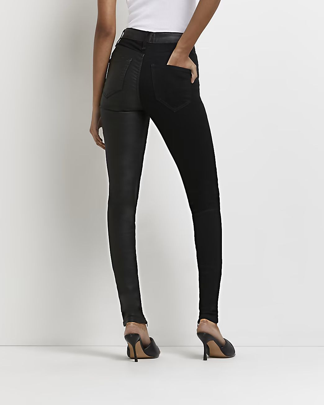 Black faux leather paneled skinny jeans | River Island (US)
