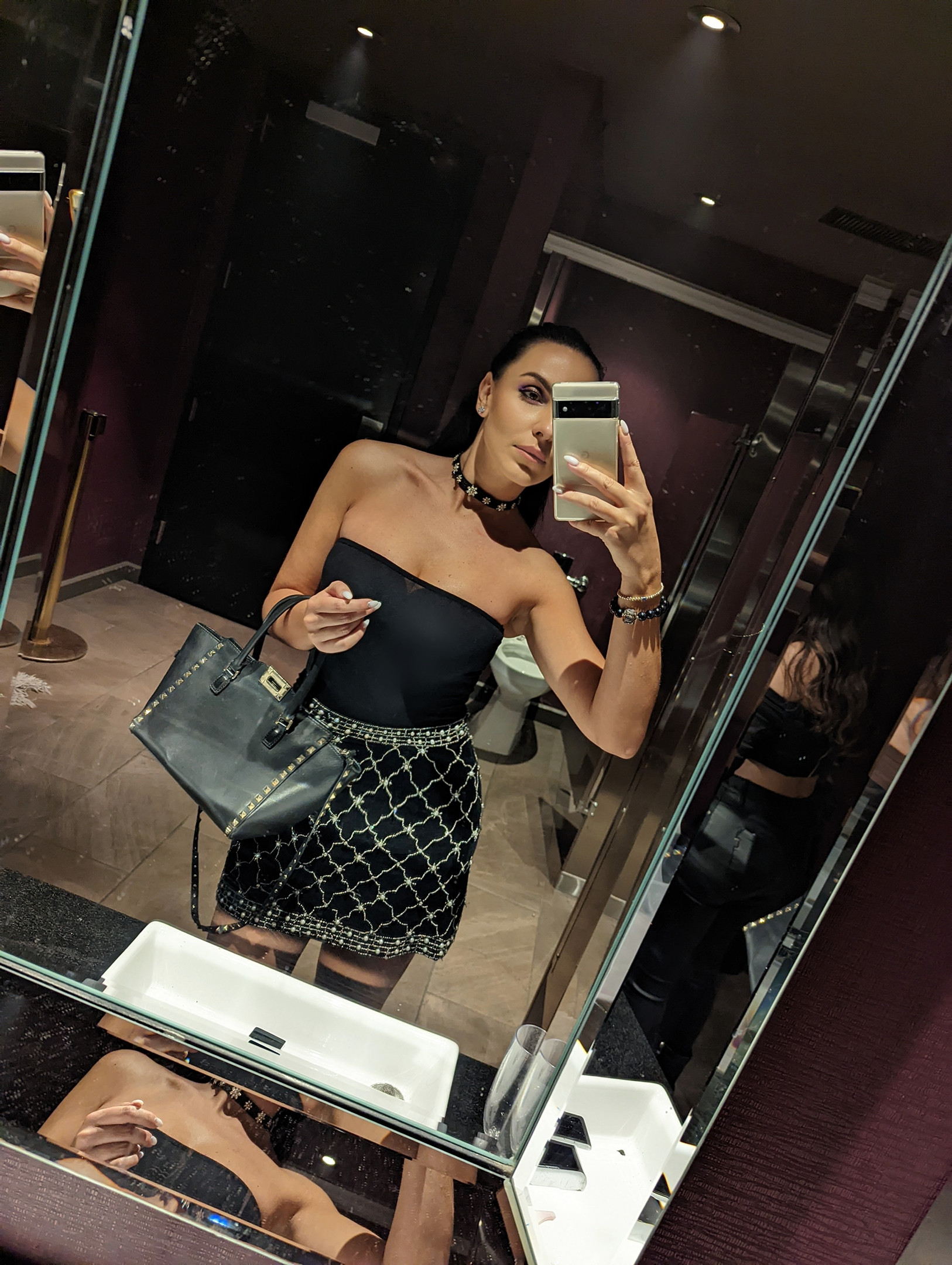 Night out glam secured! This edgy-chic look—featuring a studded mini skirt, tube top, and statement choker—is perfect for a cocktail party or dinner. That studded tote is the ultimate accessory! Tap to shop this head-turning night out fit! #NightOutLook #ChicStyle #MiniSkirt #StuddedBag #OOTN #PartyOutfit #ShopTheLook #FashionInspo 

 #LTKselfcare #LTKSaleAlert #LTKBeauty