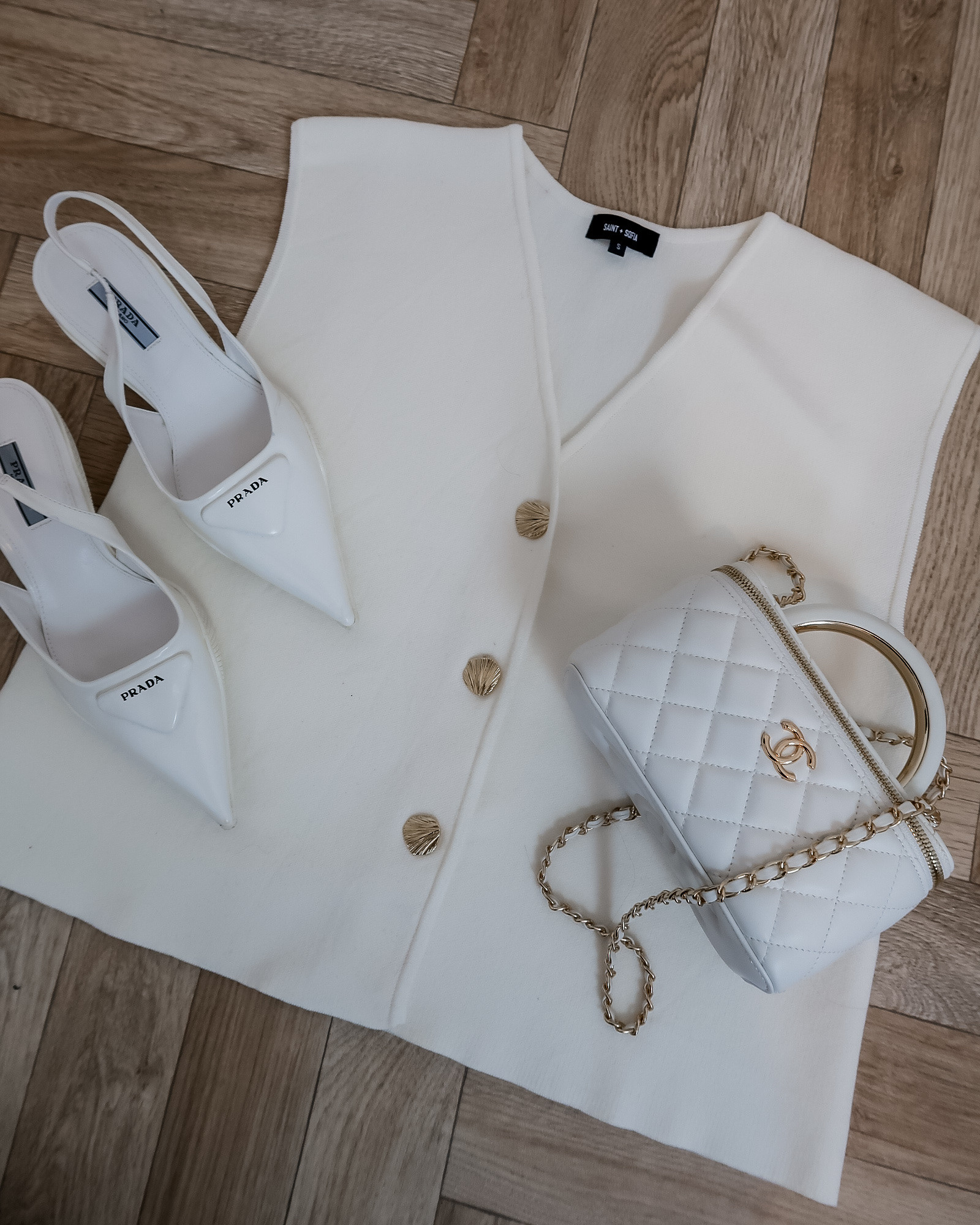 Saint + Sofia Maeva knit waistcoat cream, black tailored trousers outfit, white Prada heels outfit, Chanel vanity bag white, smart casual outfit, neutral outfit ideas, workwear chic, capsule wardrobe staples, elegant everyday style 

#LTKuk #LTKeurope #LTKspring