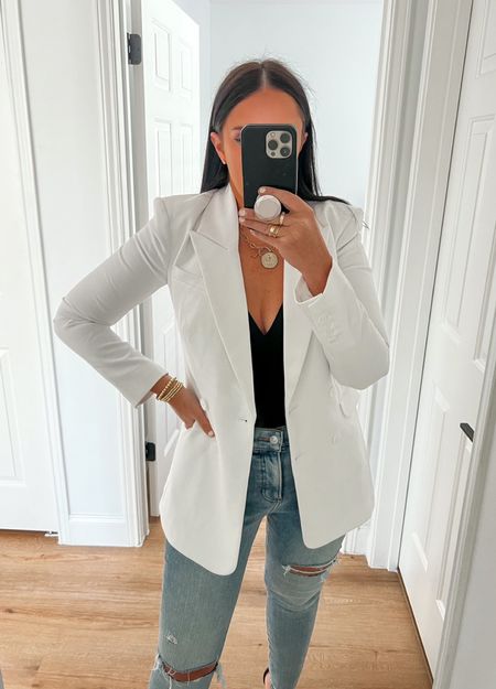 Express High Waisted Light Wash Ripped Skinny Jeans wearing size 4. Body Contour Matte V-Neck Bustier Cami wearing size medium. Peak Lapel Double Breasted Hourglass Blazer wearing size 4. 