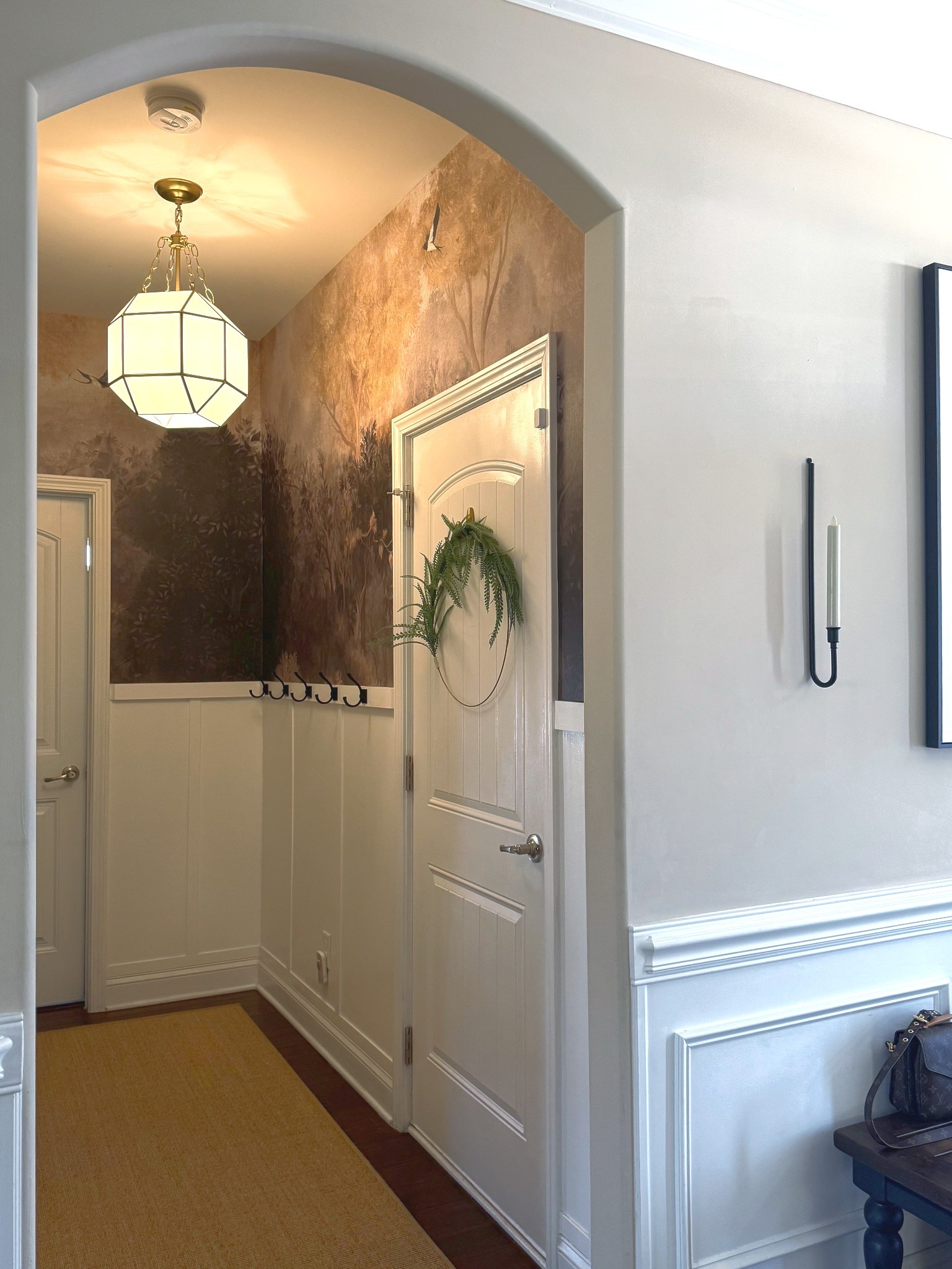 In a small space, greenery can come from a potted plant, a small tree, or even a wreath.
#homeownerentry #mudroom #chandelier

#LTKHome
