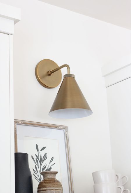 Looking for a brass sconce? I adore the look of this tapered brass sconce we installed above floating wood shelves in our kitchen. Simple, yet stylish.

#LTKFind #LTKhome