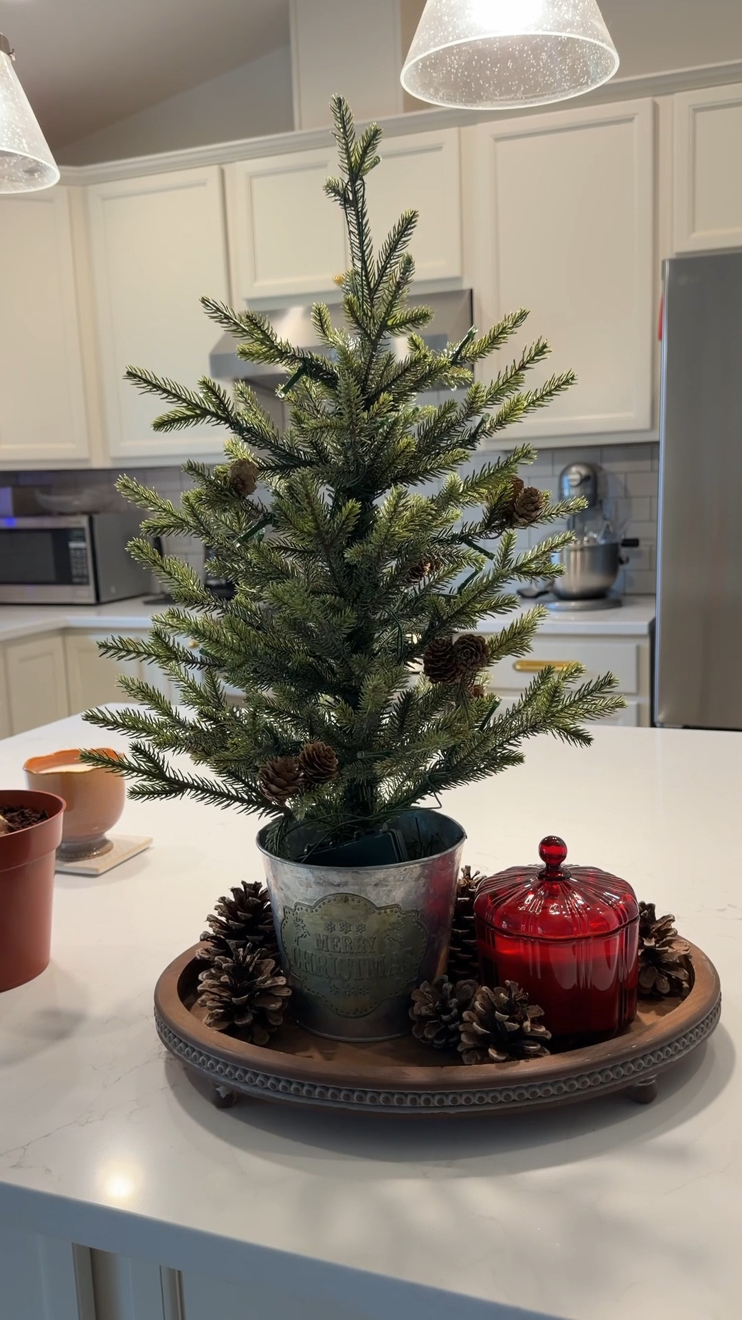 This mini Christmas tree from Wayfair is really pretty. The little pinecones are real and the metal bucket has a merry Christmas sign on it. The bucket is weighted so the tree isn’t too heavy. It comes with the lights on fully put together. I just took it out of the box and fluffed the limbs a little. 

#LTKSeasonal #LTKHome #LTKHoliday