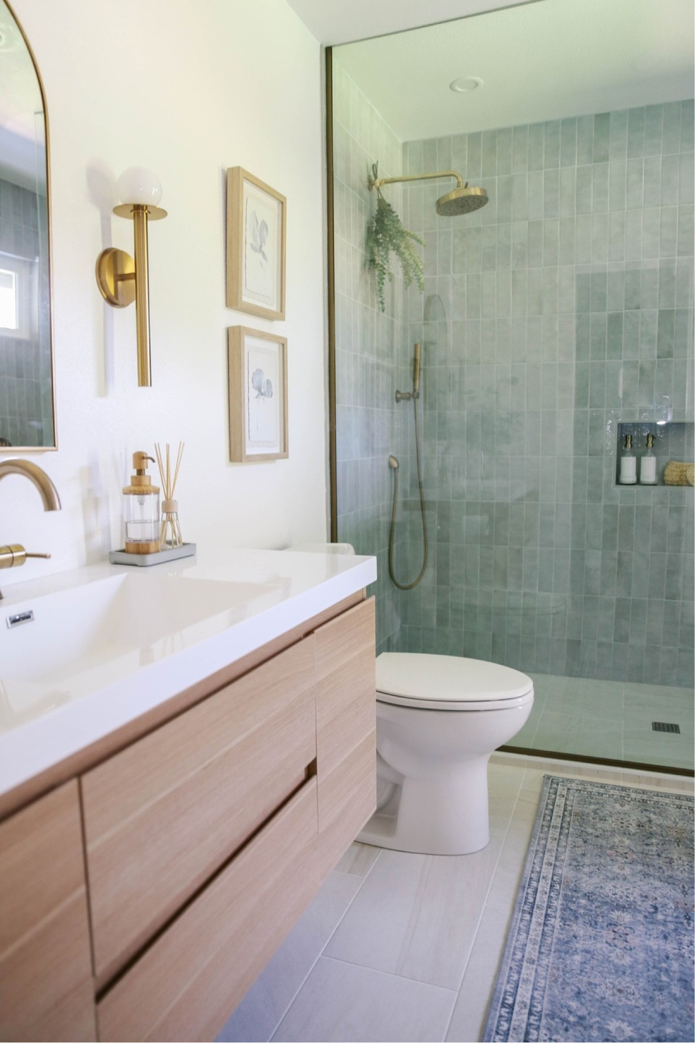 Timeless neutral bathroom renovation with brass fixtures and sea glass tile. 

#LTKhome