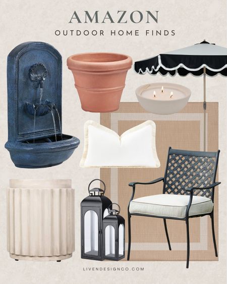Amazon patio finds. Amazon outdoor home decor. Garden. Outdoor wall fountain. Scalloped patio umbrella. Black and white patio. Wrought iron outdoor dining chairs. Outdoor lantern candle holder. Citronella candle. Terracotta planter pot. Outdoor pillow. Fringe lumbar pillow. Outdoor fluted side accent table. Cement table. Concrete table. Outdoor bordered edge rug. Neutral rug. 

#LTKSeasonal #LTKHome #LTKStyleTip