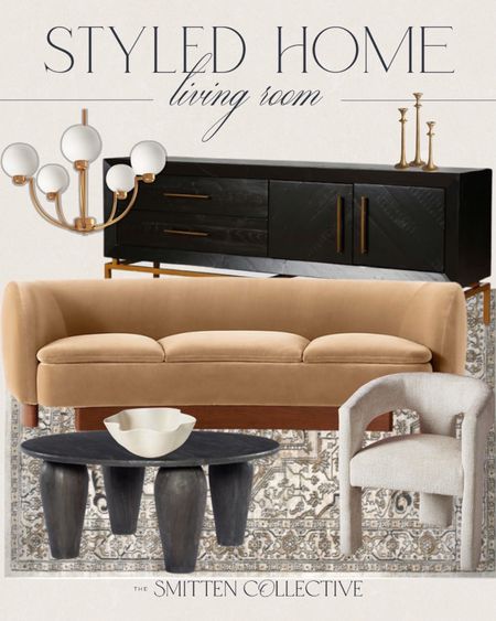 Styled living room includes sofa, black buffet cabinet, gold chandelier, gold candle holders, black round coffee table, white accent chair, area rug, wave decorative bowl.

Home decor, home accents, moody decor, modern vintage decor, living room decor

#LTKhome #LTKstyletip #LTKfindsunder100