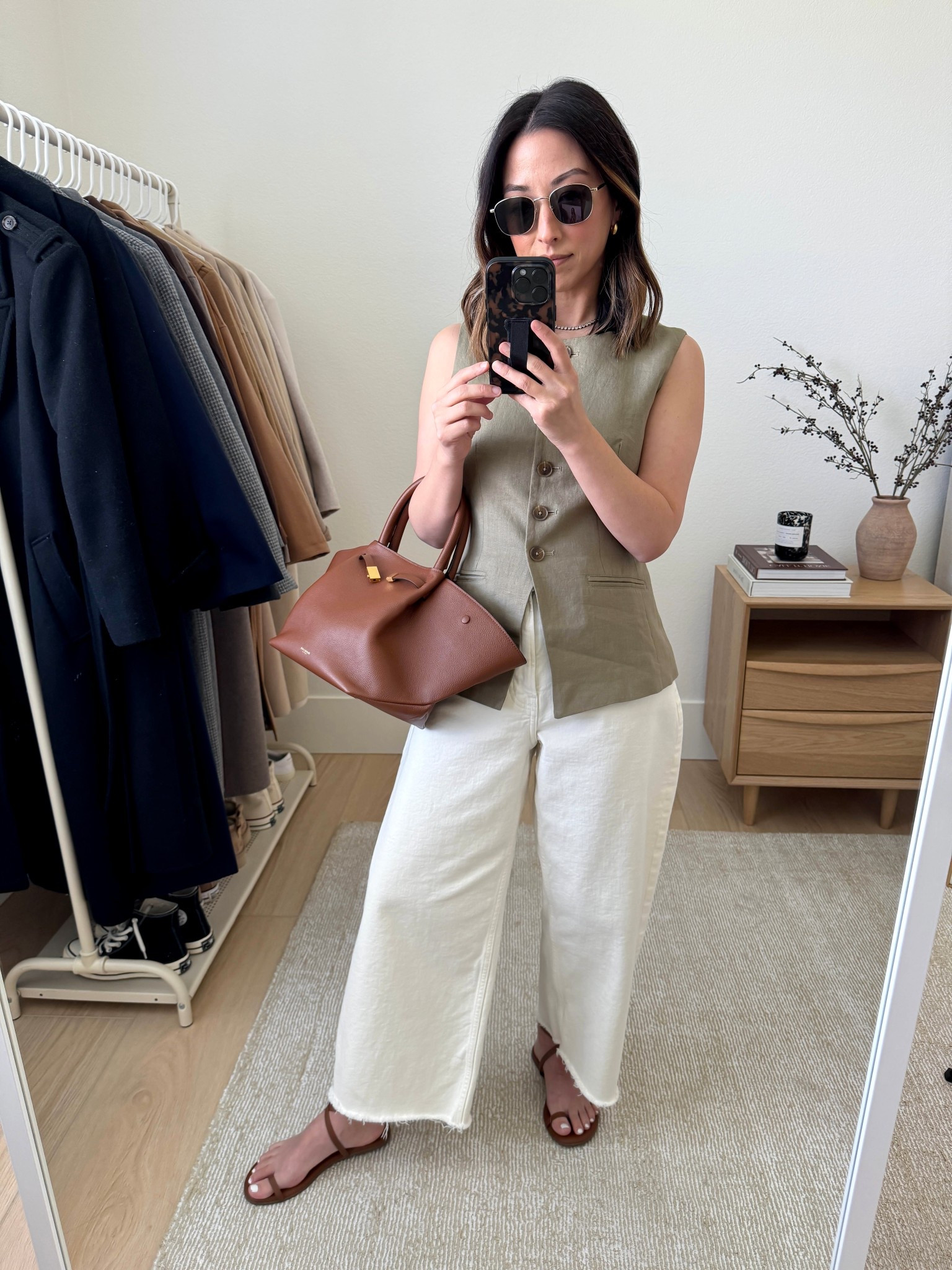 Linen vest from J.Crew. Has a cinched back which is perfect! Runs tts. Great fit on petites

J.Crew vest 0
Everlane jeans 26. Sized up 2 sizes and cut hems
Tkees sandals 5
DeMellier bag medium
Le Specs sunglasses
Madewell earrings (old)