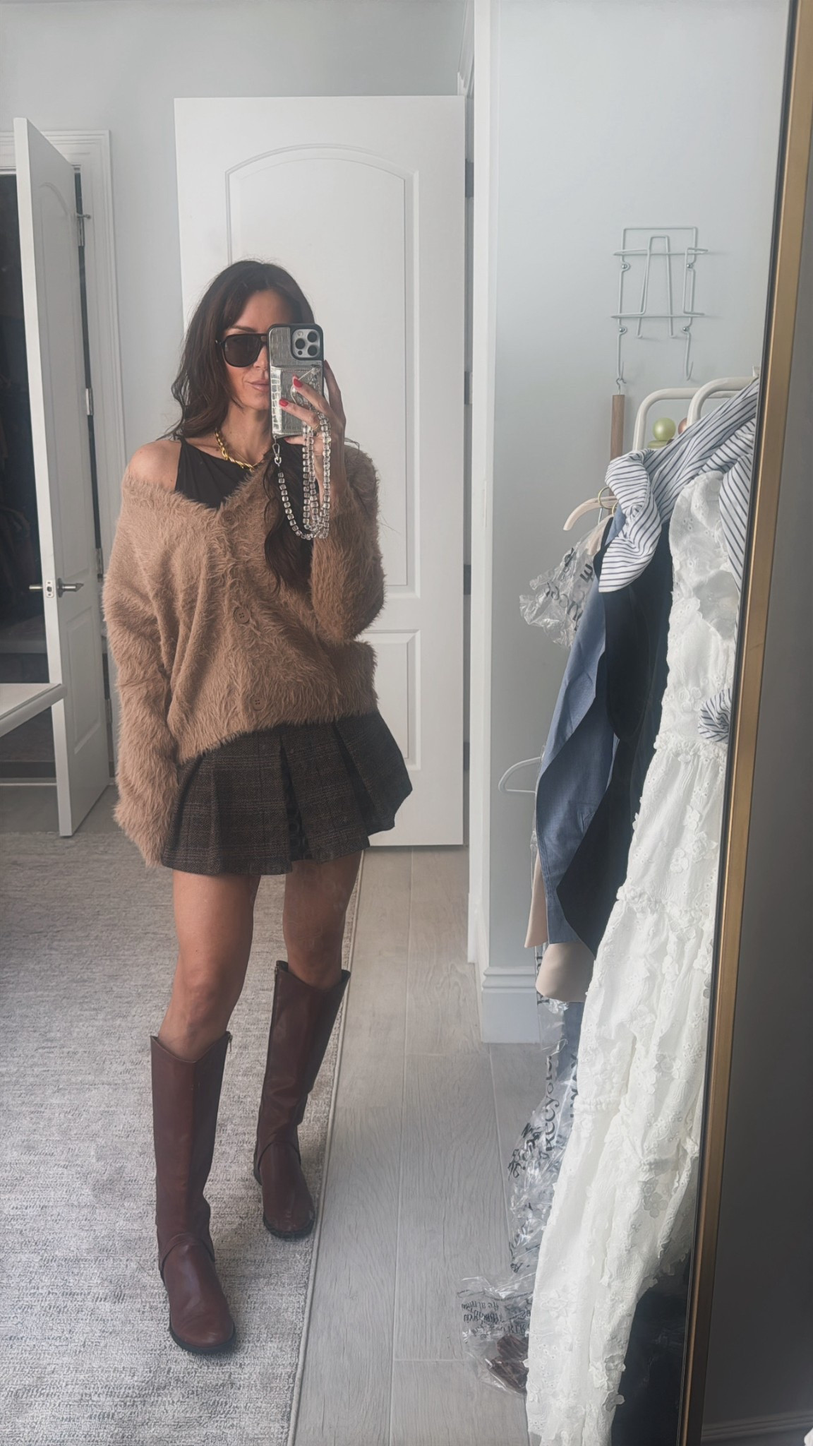 The Coziest cardigan there ever was is a must! I paired it back to a polo Ralph Lauren skirts pulled out my writing boots from the corner of my closet and added a fuel cold and touches. 

#LTKFindsUnder100