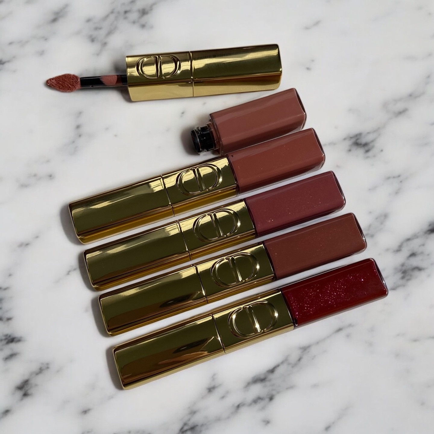 Sharing swatches & my thoughts on the new Rouge Dior Sequin Lip Duo ✨From The Holiday 2025 Collection

From Top To Bottom: 
220 Ribbons 
100 Spectacular Nude
420 Pink Star 
520 ILLusionist 
881 Carousel 

The packaging is luxe and festive — a double-ended design with a pigmented liquid lipstick on one side and a clear gloss on the other. The liquid feels lightweight and creamy but dries down to a semi-matte, shimmering finish once set.The sparkle effect is beautiful, it really catches the light like real sequins — perfect for nights out or special occasions. You can go subtle or full glam depending on how much gloss you layer. Surprisingly, it feels quite comfortable for a glitter formula not too heavy or gritty.Shade 520 ILLUSIONIST doesn’t have too much shimmer, which makes it wearable even for daytime looks.However, it’s not for ultra-matte lovers,the sparkle + gloss finish sits somewhere in between, and it’s not transfer-proof once you add the gloss. I also noticed a bit of sparkle moving outside the lip line, and some shades apply patchier than others.For the price, I wish there were more finish options maybe a mix of matte and shimmer duos so everyone can choose what they love. Personally, I’ll reach for it once in a while,but not as an everyday lipstick.Overall fun, lightweight, and beautiful just not my go-to formula. Definitely a matter of personal taste! My Review Based on my own personal experience.🫶

#diorbeauty #diorsequinlipstick #diorholiday2025 #review

#LTKBeauty #LTKSeasonal