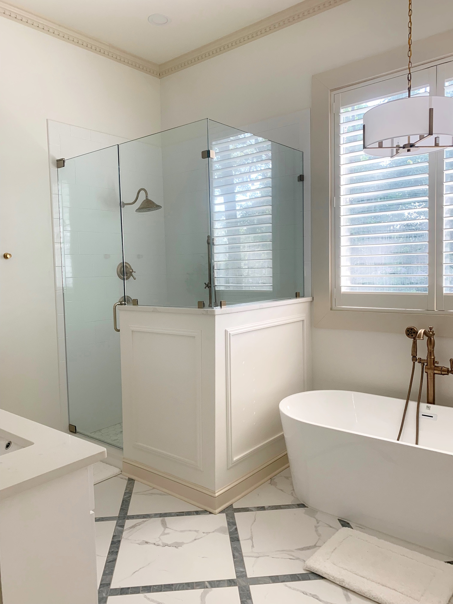 Primary bathroom details 🛁 | free standing soaking bathtub | brass drum chandelier | Delta champagne bronze plumbing fixtures | white bathroom 

#LTKhome