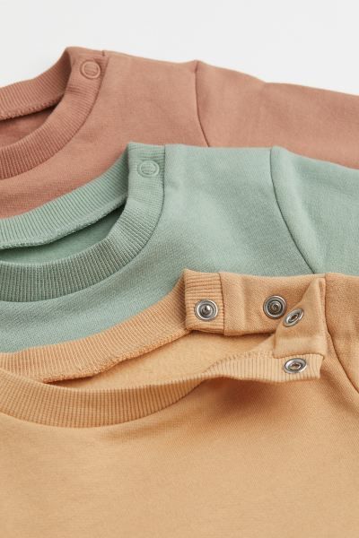 Conscious choice  Crew-neck sweatshirts in cotton fabric with soft, brushed inside. Snap fastener... | H&M (US + CA)