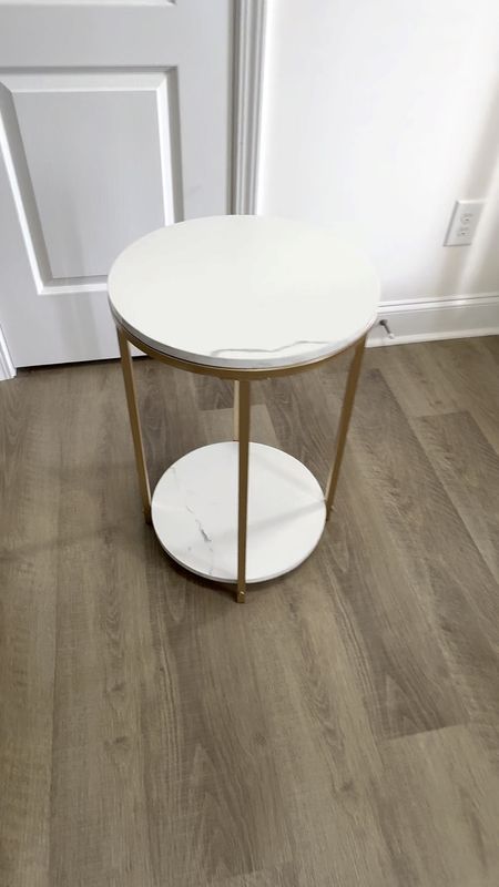 Faux white marble small side table. Gold colored legs and two shelves.

#LTKFamily #LTKHome