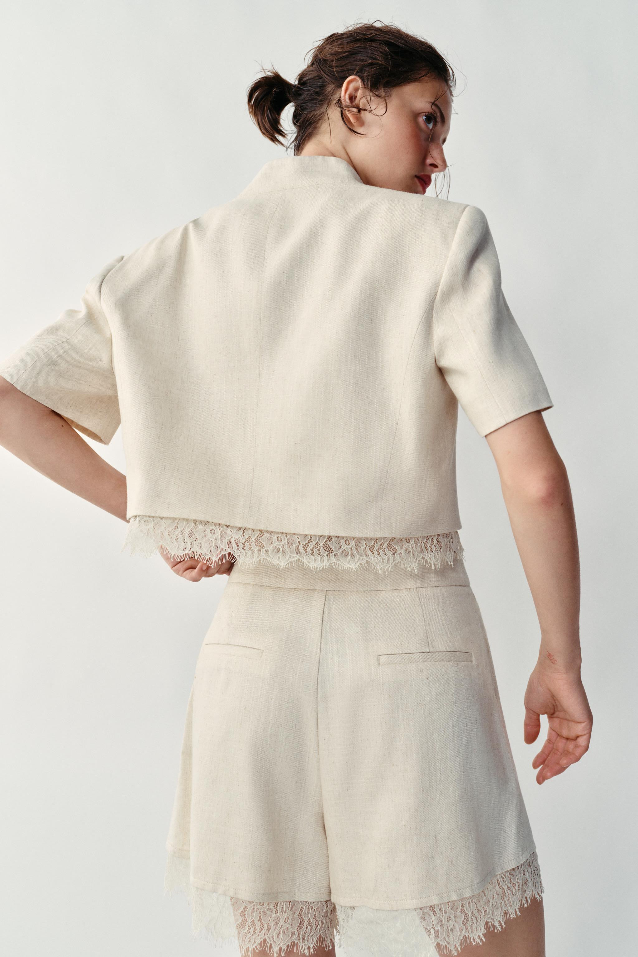 Model height: 176 cmBlazer with a collarless neckline and short sleeves with shoulder pads. Featu... | Zara UK