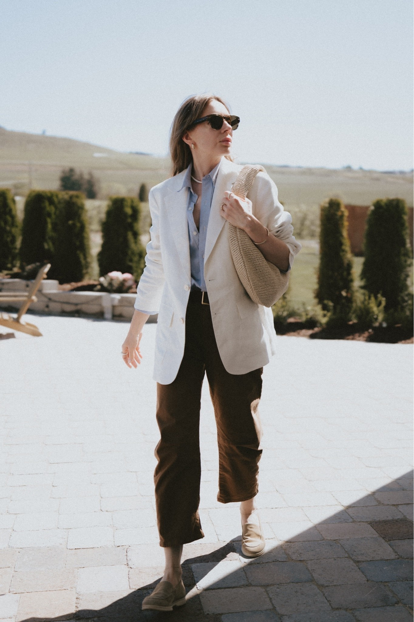 A white linen blazer + neutral colored barrel leg pants + blue button down shirt + white sole boat shoes + straw shoulder bag.
Blazer & shirt: Buck Mason
Pants: Nili Lotan
Suede shoes: Paul Green, similar linked
Bag: Cos

#LTKootd #LTKSeasonal #LTKWorkwear
