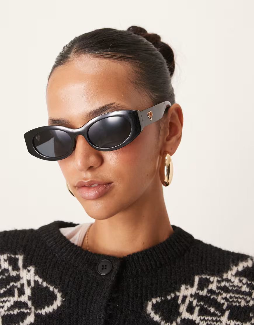 ASOS DESIGN oval sunglasses in black with heart charm detail | ASOS (Global)
