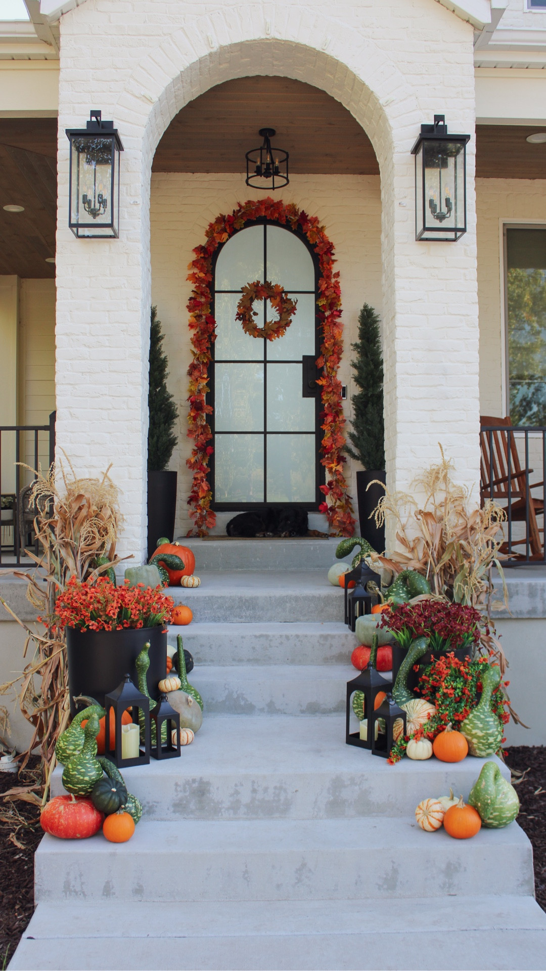 Nothing says “welcome home” like a cozy fall porch 🍂🎃 The @veradek planters were the perfect starting point for layering pumpkins, lanterns, and garland to create an inviting seasonal look. #gifted 

🤎Follow @home_is_calling for more seasonal home inspo! 

#fall #falldecor #porchdecor #homedecor #homeinspo #homedesign #frontporch #fallinspo #planterpot