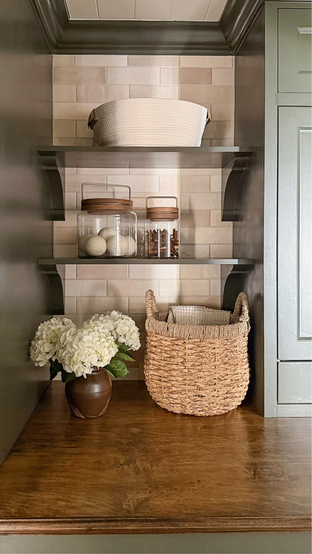 My laundry room shelves! The cabinet paint color is Fatigue Green by Benjamin Moore

Glass canisters, storage baskets, laundry basket, small glazed ceramic vase, laundry room decor

#LTKStyleTip #LTKHome