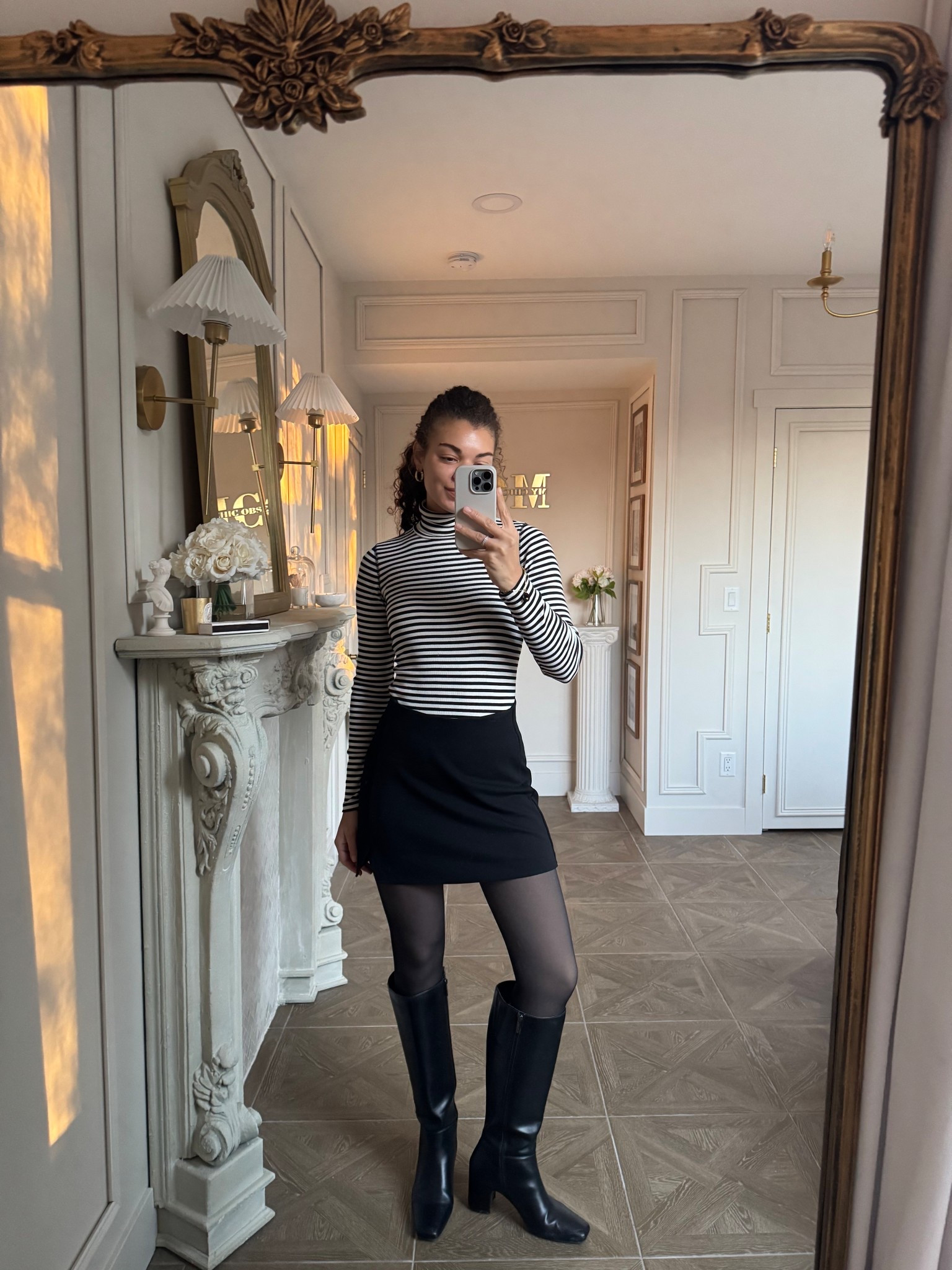 Channeling Parisian chic style with this striped turtleneck, black mini skirt, fleece tights, and knee-high boots

#LTKootd
