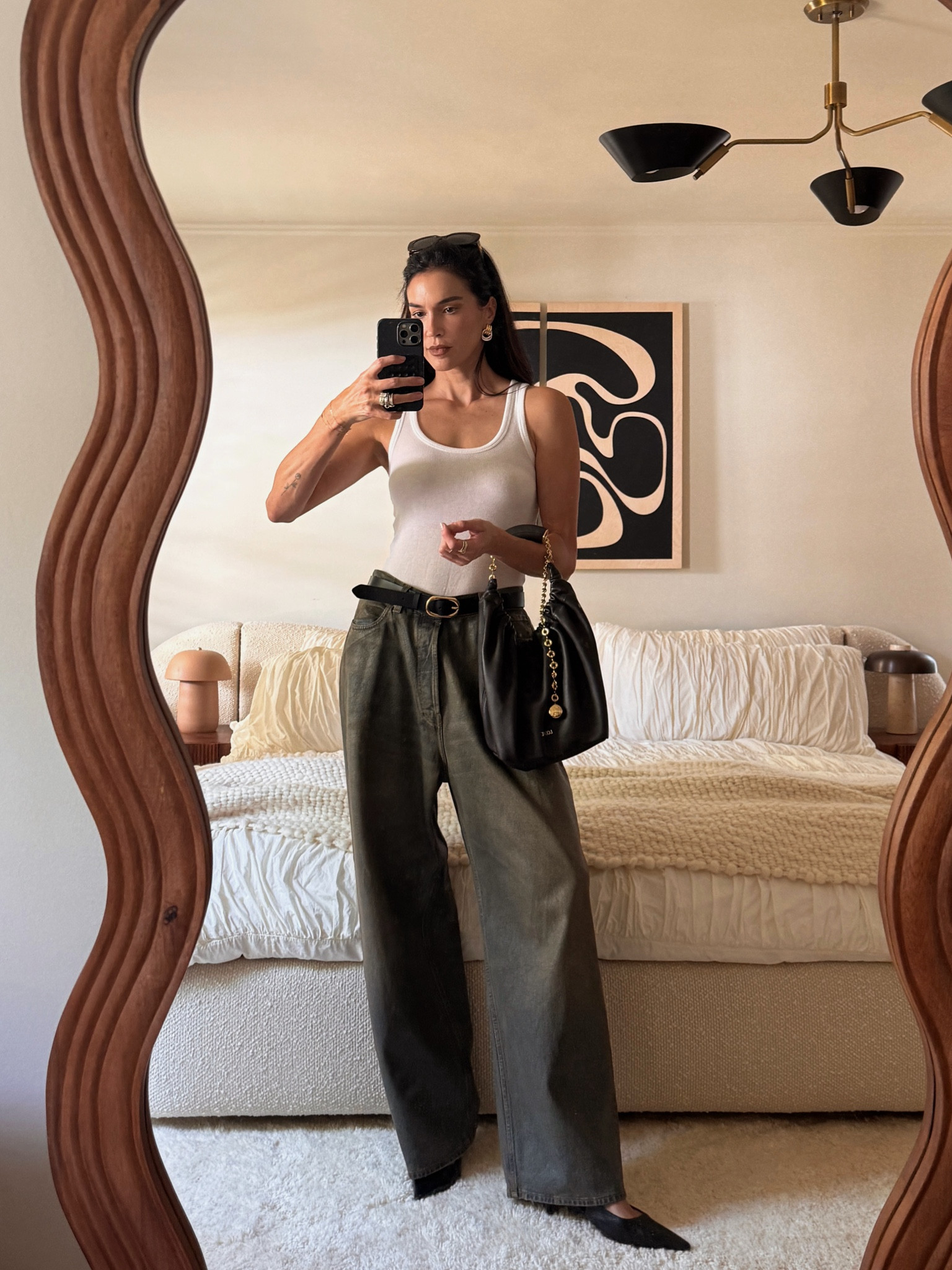 love how comfortable and simple this look is. It’s so hot here rn in LA and that makes it difficult to style outfits without layers. Adding a belt and a bag w/ chain detail like this pulls it all together for me. This bag is so good to travel with as it lays flat in my suitcase. I’m 5’10 and wearing a size 28 in the jeans. Having a belt is key bc otherwise they would sit lower than I like. 

#LTKItBag #LTKStyleTip 
