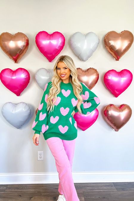 Macy20 for 20% off! Valentine’s Day. Heart balloon wall. Heart sweater. Pink jeans. Valentine’s Day outfit. 

#LTKSeasonal #LTKfindsunder100