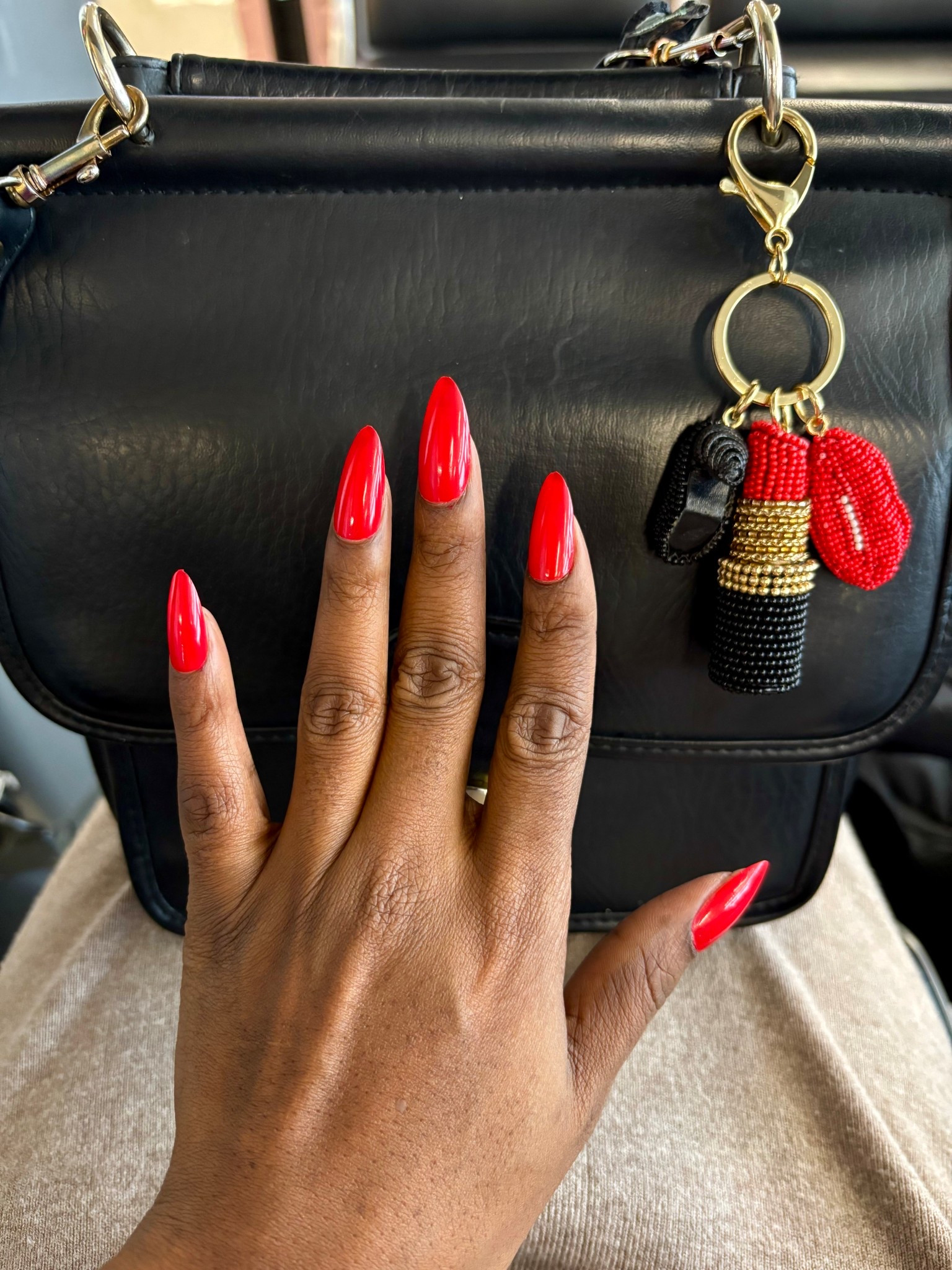 Mixing classic with trendy. Classic black bag and red nails, with a trendy lipstick bag charm 💋 

#LTKHoliday #LTKGiftGuide #LTKFindsUnder50