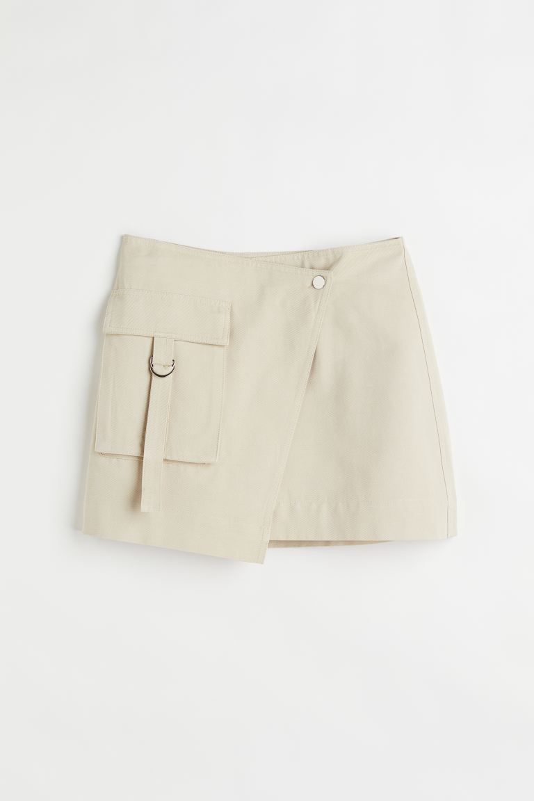 Mini skirt in a lyocell and cotton weave with a high waist and a wrapover front with a press-stud... | H&M (DE, AT, CH, NL, FI)