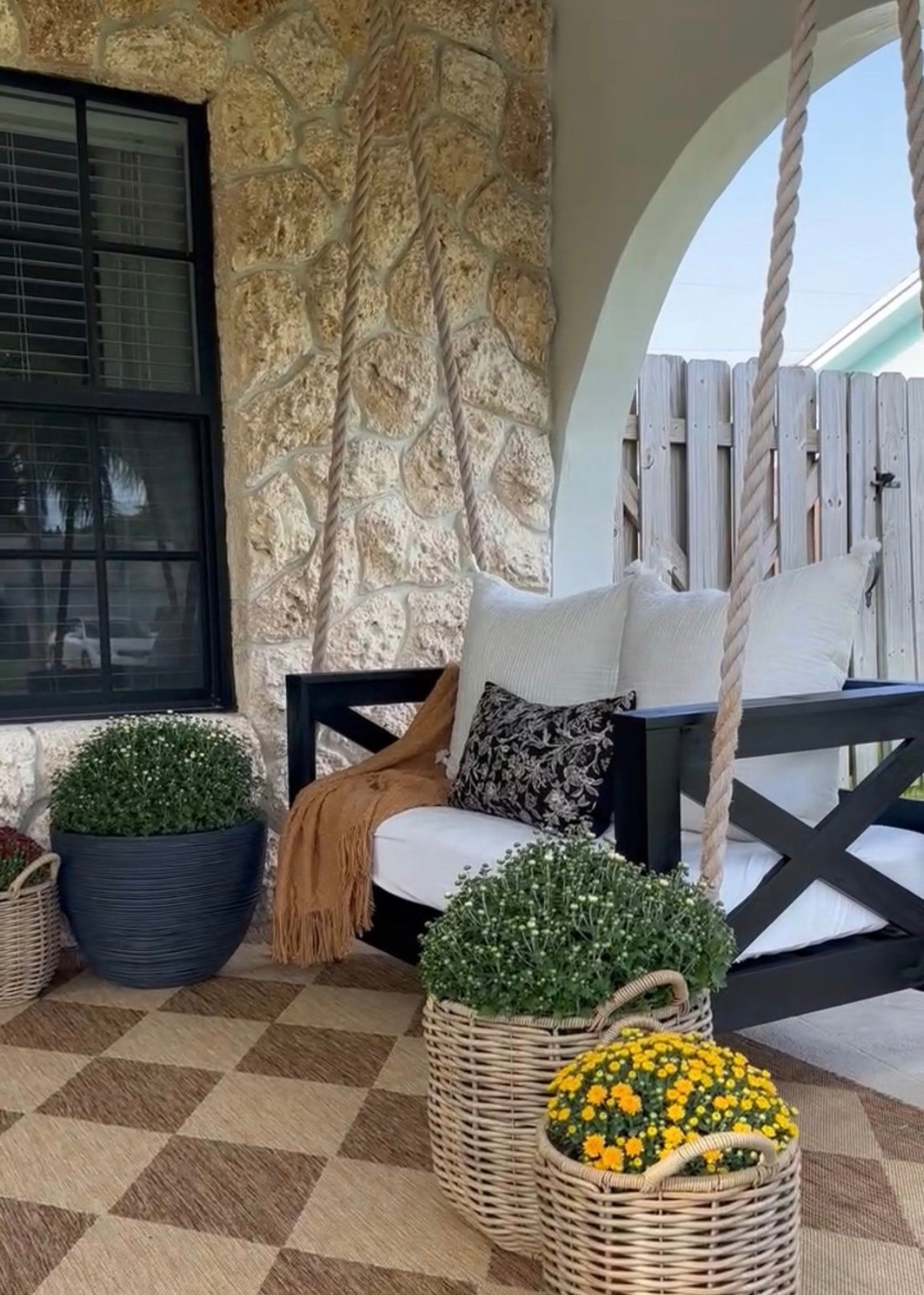Fall front porch swing. Layered in these cozy textures with pillows, a rust color throw blanket and this neutral checkered rug. Mums are always a must for Fall! 

Fall front porch 
Fall
Autumn 
Cozy home 
Front porch 
Fall porch decor
Home decor
Front door decor 
Pottery barn 
Amazon 
McGee and co
Studio McGee
Walmart 
Magnolia 
Cottage 
Garden
Stone
Pumpkins
Rug 
Outdoor rug 
Checkered rug 
Neutral home

#LTKHome #LTKSaleAlert #LTKSeasonal