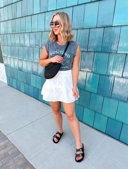 Sunday lunch OOTD 💙 Having @eatflowerchild near us is going to be dangerous 😆🙌🏻 This tee is under $15 and so cute for Summer! Sharing everything in stories and you can shop it via the link in my bio > Shop my Reels/IG Posts 🛍️➡️

Size medium tank, size small skirt!
•Biker shorts size medium (4 inch)
Sandals on sale (I’m a size 7.5 and prefer the size 37 but technically size 38 fits too)

Casual outfits, skirts, tees, belt bags 

#LTKStyleTip #LTKSaleAlert #LTKFindsUnder100