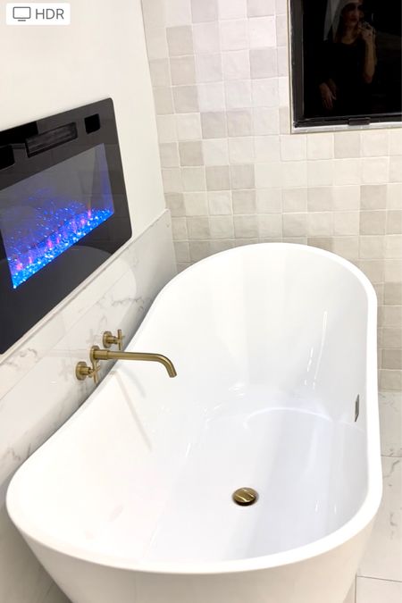 Fav room of the house.. this bathroom. Love the gold trim around the window that matches the facets and drain. This electric fireplace comes in array of sizes. It’s on sale today. Also, has the option for heat or no heat. Such a relaxing space. 🛀

#LTKsalealert #LTKbeauty #LTKhome