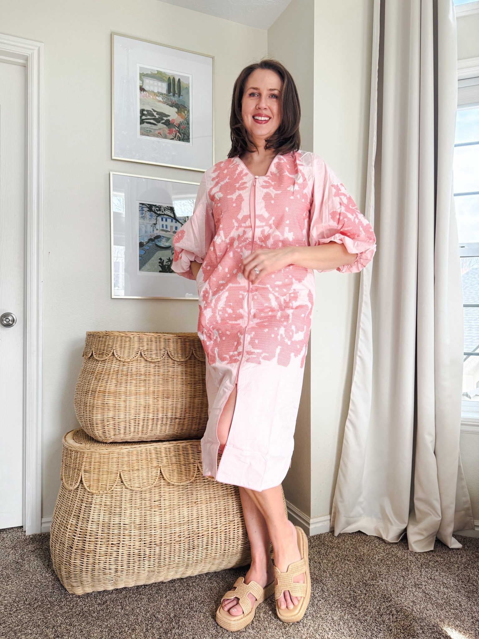 A pink puff sleeve midi dress for Easter, spring, and more!

This affordable midi dress has a zipper front and floral print. I’ve paired it with a wicker bag and raffia sandals. (I’m wearing a size large).
 @ltk 

#date night outfits #spring outfits 2026 #spring dresses #easter dress women #vacation outfits beach #ltkshoecrush

#LTKTall #LTKootd #LTKOver40

