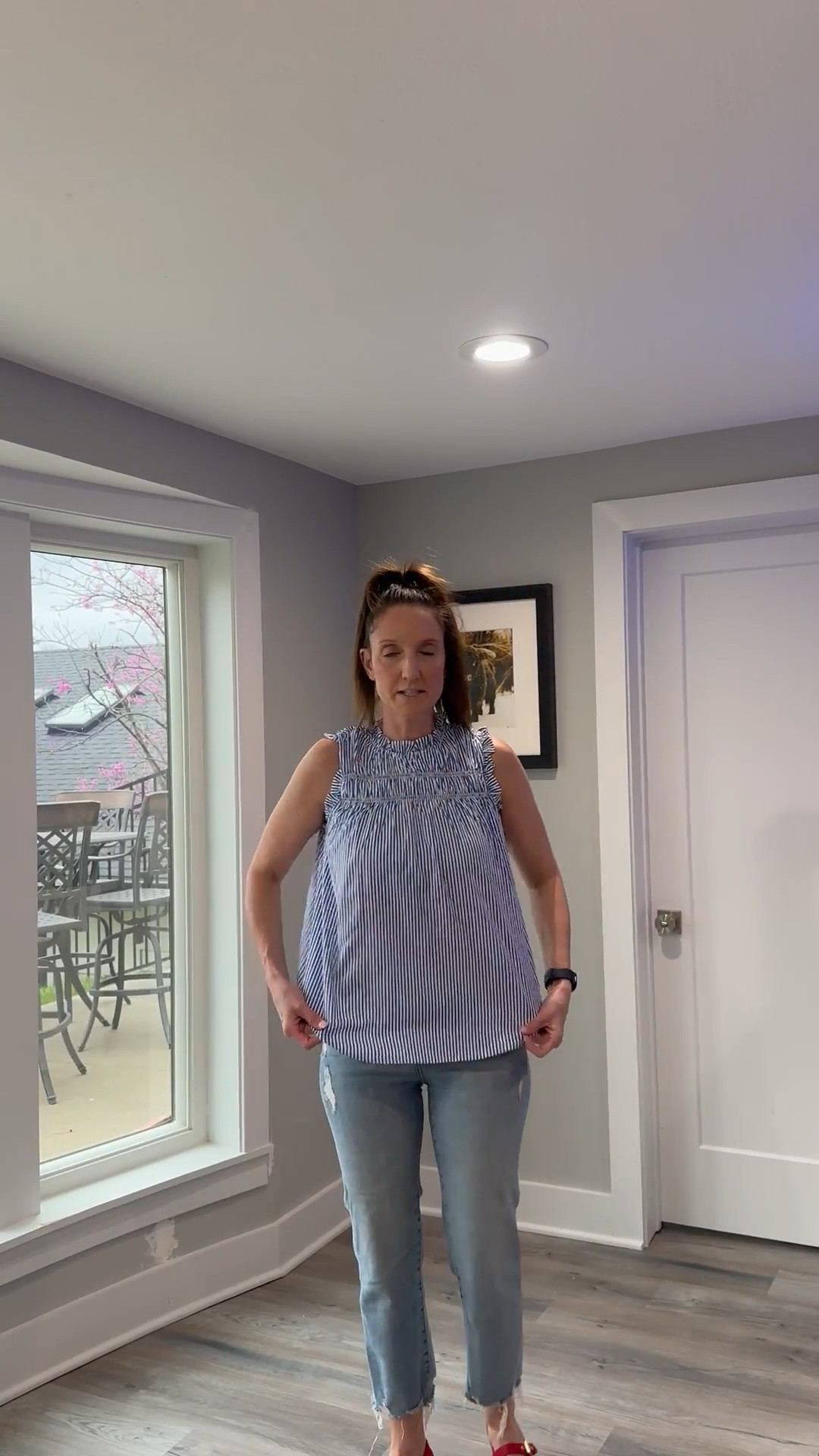 Sticking to timeless patterns and relaxed shapes for a perfectly productive day. 🎀🌟 This sleeveless striped piece is my secret to staying cool while looking completely put-together. Check out the link in my bio to shop this look and refresh your own warm-weather rotation! 🌟 #StyleInspo #BlueAndWhite #SummerOOTD #ShopMyLook

My Stripes & Smocking Style Breakdown
• The Top: I’m wearing a sleeveless blue and white vertical striped top featuring a high neckline with intricate smocking and ruffle detailing.
• The Denim: I paired the top with light-wash, straight-leg jeans that include a trendy raw-edge hem at the ankle.
• The Accessories: I’ve kept the styling minimal with my everyday black fitness tracker to maintain a practical aesthetic.
• The Hair: I’ve pulled my hair back into a sleek, high ponytail to keep the focus on the beautiful smocked collar.
• The Vibe: This outfit is the definition of "polished versatile"—it captures a fresh, organized energy that is perfect for a social outing with Tristan.

blue and white stripes, smocked top, sleeveless blouse, high neck top, raw hem jeans, light wash denim, casual summer outfit, feminine everyday style, effortless chic look, LTKstyle, stitchfix haul 

#LTKOver40 #LTKdayinmylife #LTKmomlife

#LTKootd #LTKOver40 #LTKmomlife