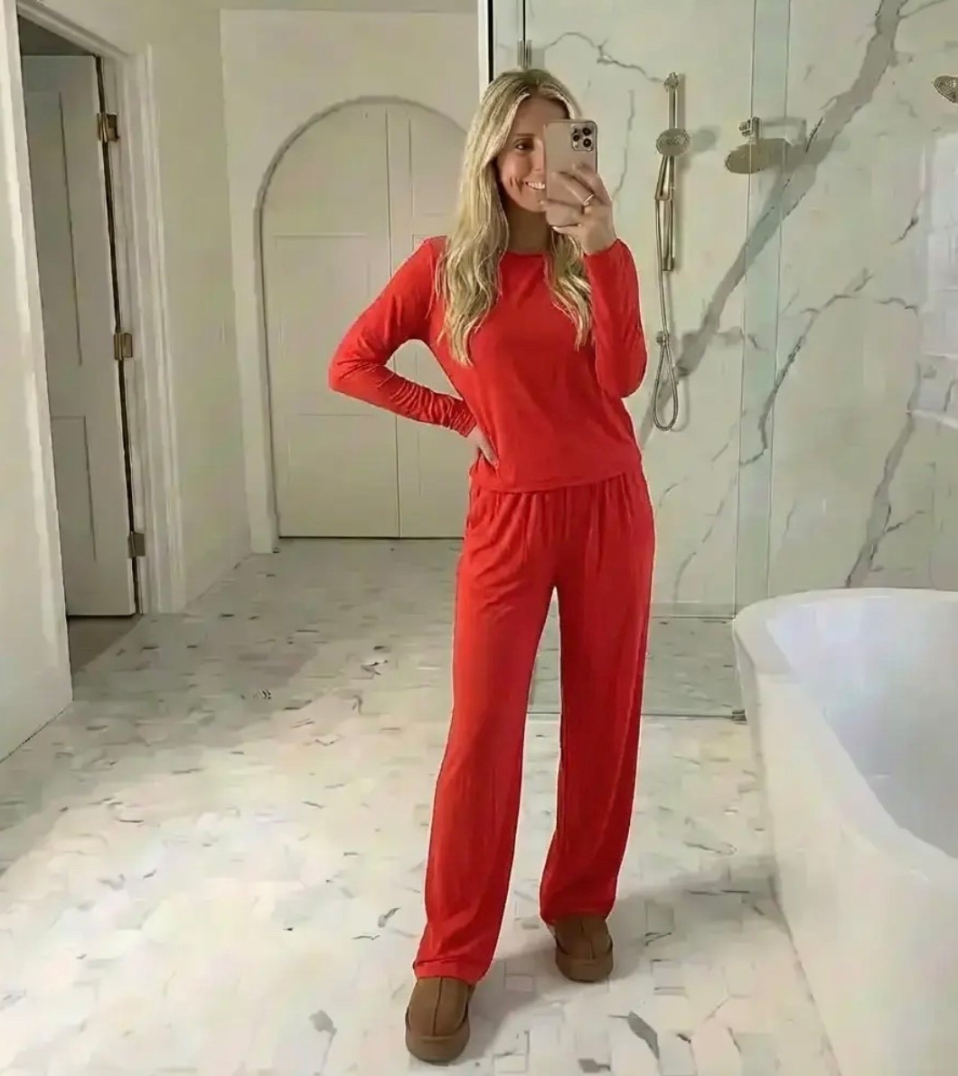 A confident woman taking a mirror selfie in a bright, luxury bathroom with white marble floors and walls, subtle gray veining, and modern chrome fixtures. She’s wearing a relaxed, matching red lounge set with a long-sleeve top and loose straight-leg pants, paired with cozy brown slippers. Soft natural lighting fills the space, creating a clean, minimalist, elevated home aesthetic. Effortless, cozy, chic, and modern lifestyle vibes — calm, put-together energy with a hint of luxury.

⸻

Hashtags

#CozyButChic
#LoungewearStyle
#EffortlessStyle
#HomeStyle
#CasualChic
#LuxuryAtHome
#ModernLiving
#NeutralHome
#RelaxedFit
#EverydayStyle
#MirrorSelfie
#CleanAesthetic
#ComfyFashion
#MinimalStyle
#QuietLuxury
#StayHomeStyle
#ChicComfort
#LifestyleContent
#TrendyHeidi
#AtHomeVibes

#LTKGiftGuide #LTKHoliday #LTKdayinmylife