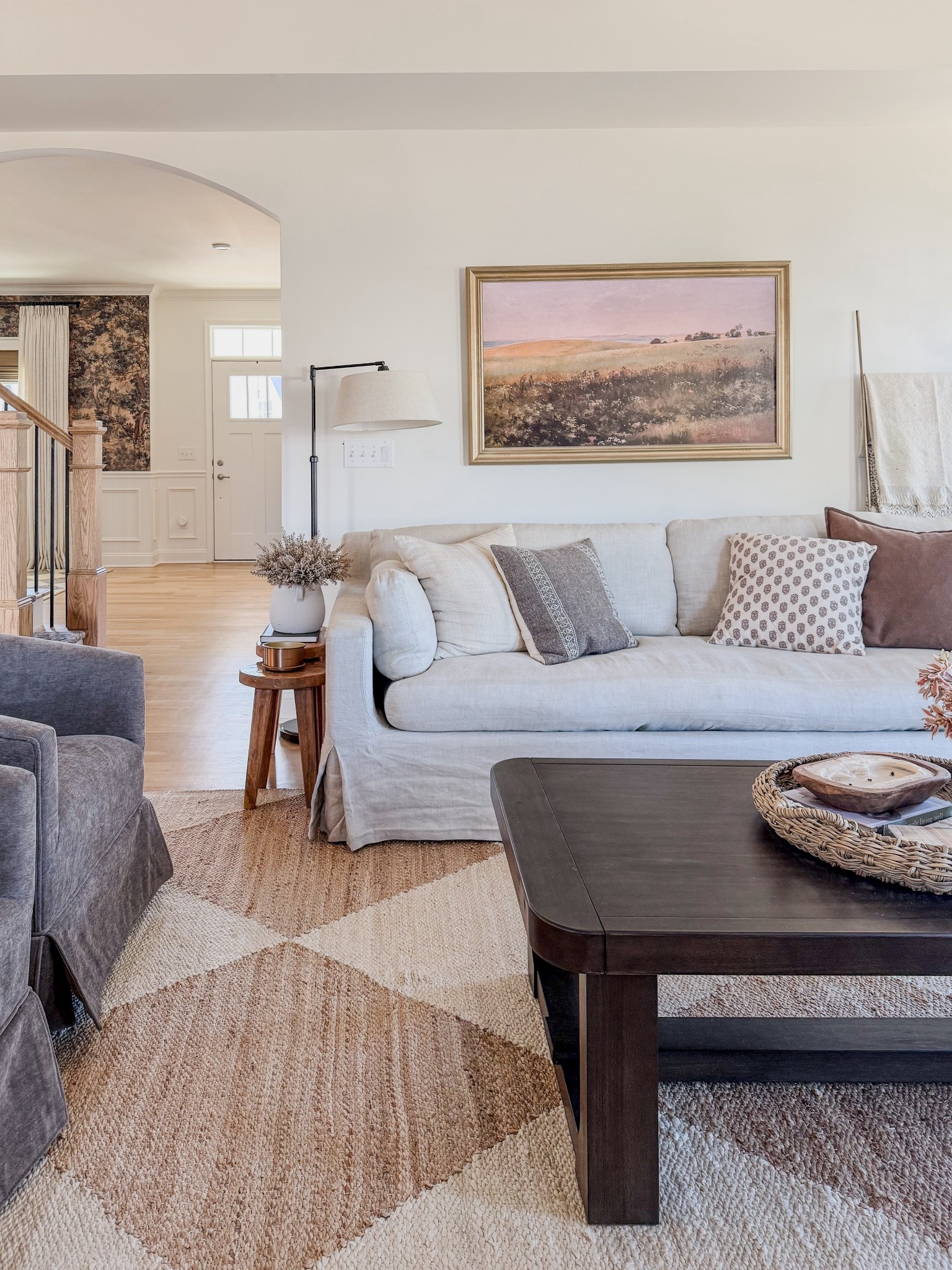 Moved our living room around, placed the frame tv under the couch so it’s no longer the focal point of the space, swivel chair make great conversation seating 

#LTKSaleAlert #LTKHome #LTKOver40