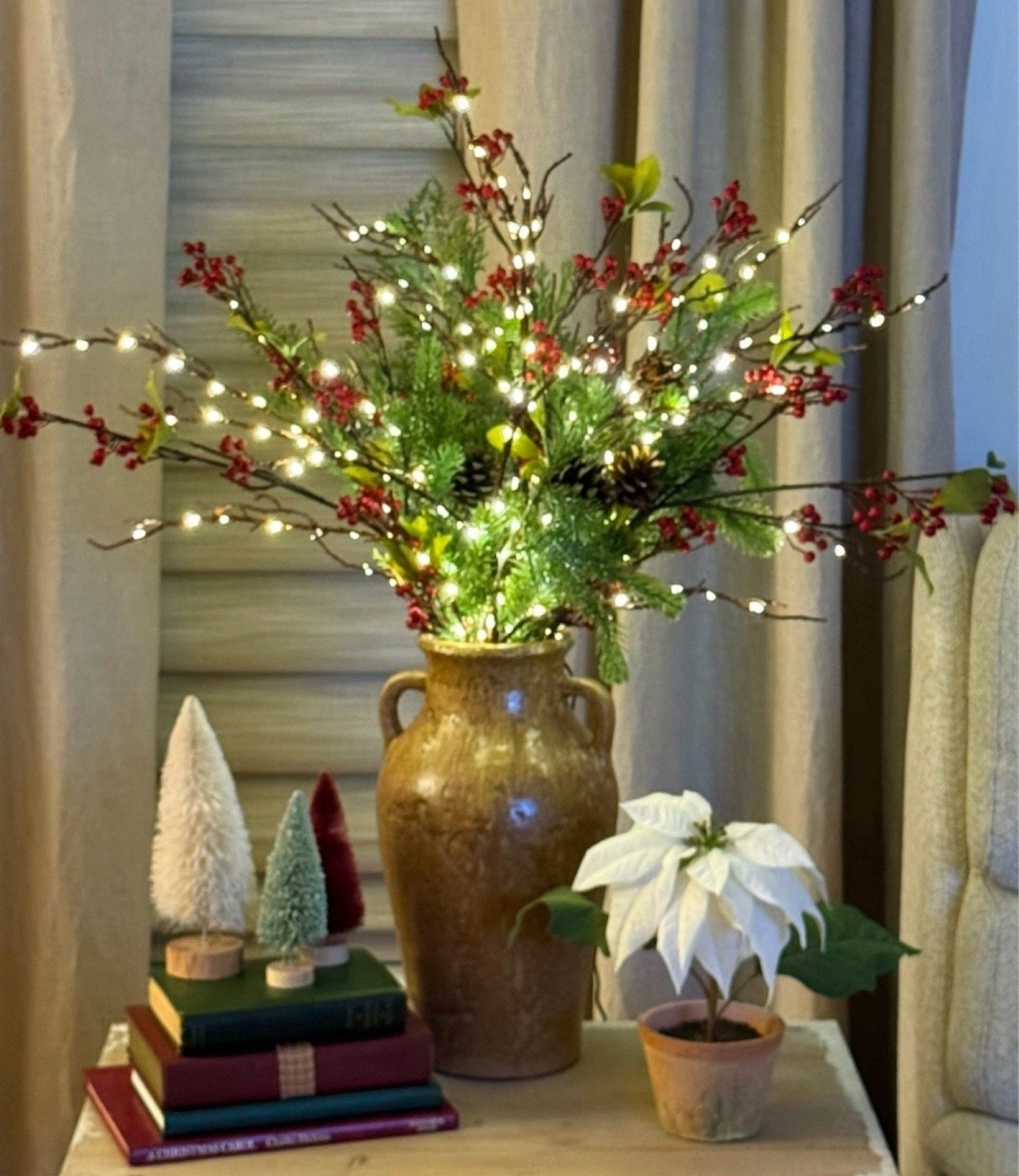 These pretty electric brown willow branches come with 200 fairy lights with a timer and dimmer…perfect for the holiday season and thru the wintertime to keep some sparkle in your home. One of my favorite purchases this season are these pine stems that come in a bundle of 22 stems. They are still on sale for $18.89. Also pretty berry stems, my sweet white poinsettia plant, some cute bottle brush and table top trees on sale, and some similar vases to mine  

#LTKSaleAlert #LTKHoliday #LTKHome
