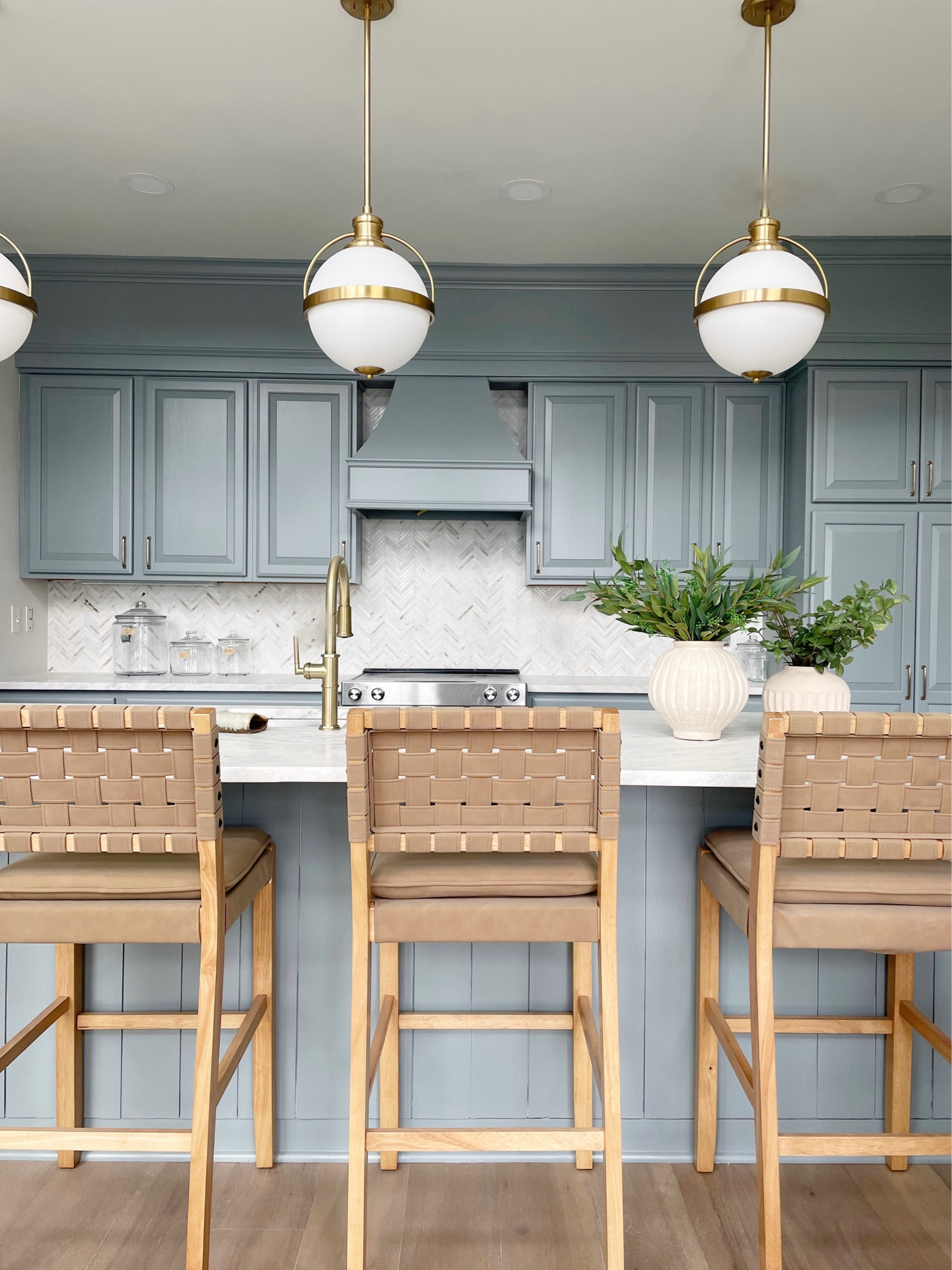 Modern coastal kitchen 
Blue kitchen cabinets 
Coastal barstools
Kitchen barstools 
Marble herringbone backsplash 


#LTKHome